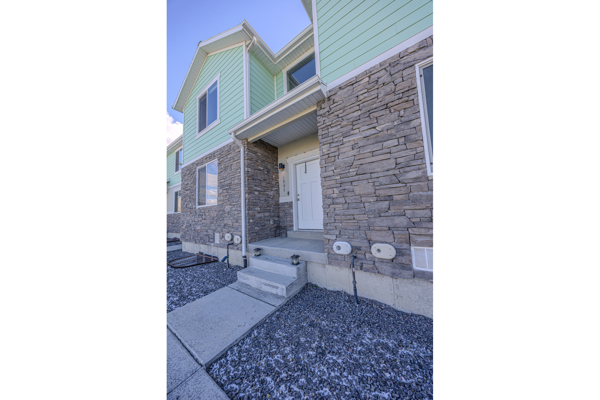 Doorway to property featuring stone siding