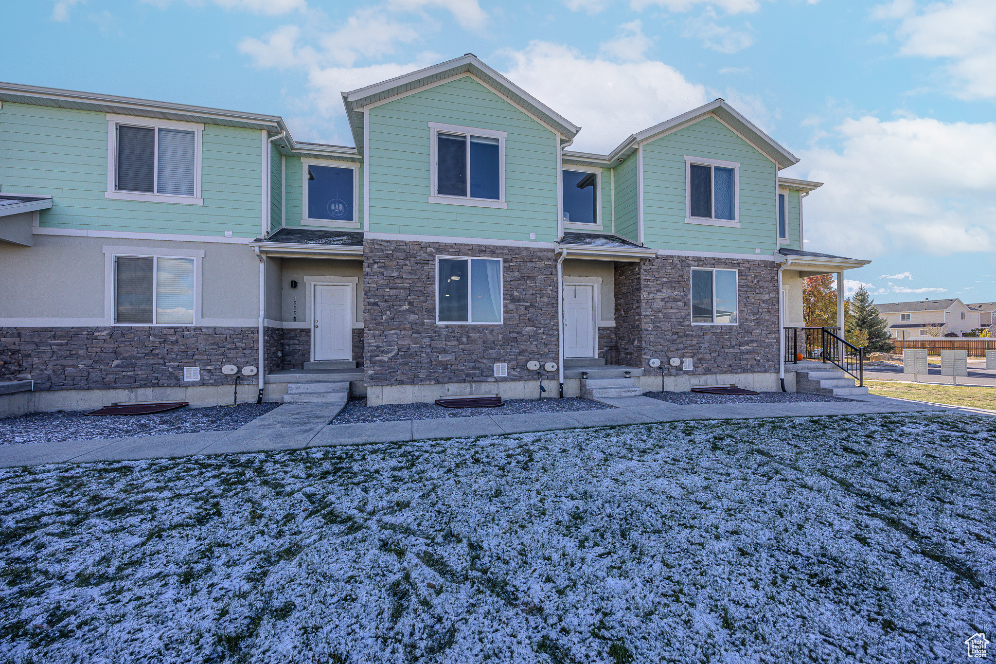 View of front of property featuring stone siding and crawl space