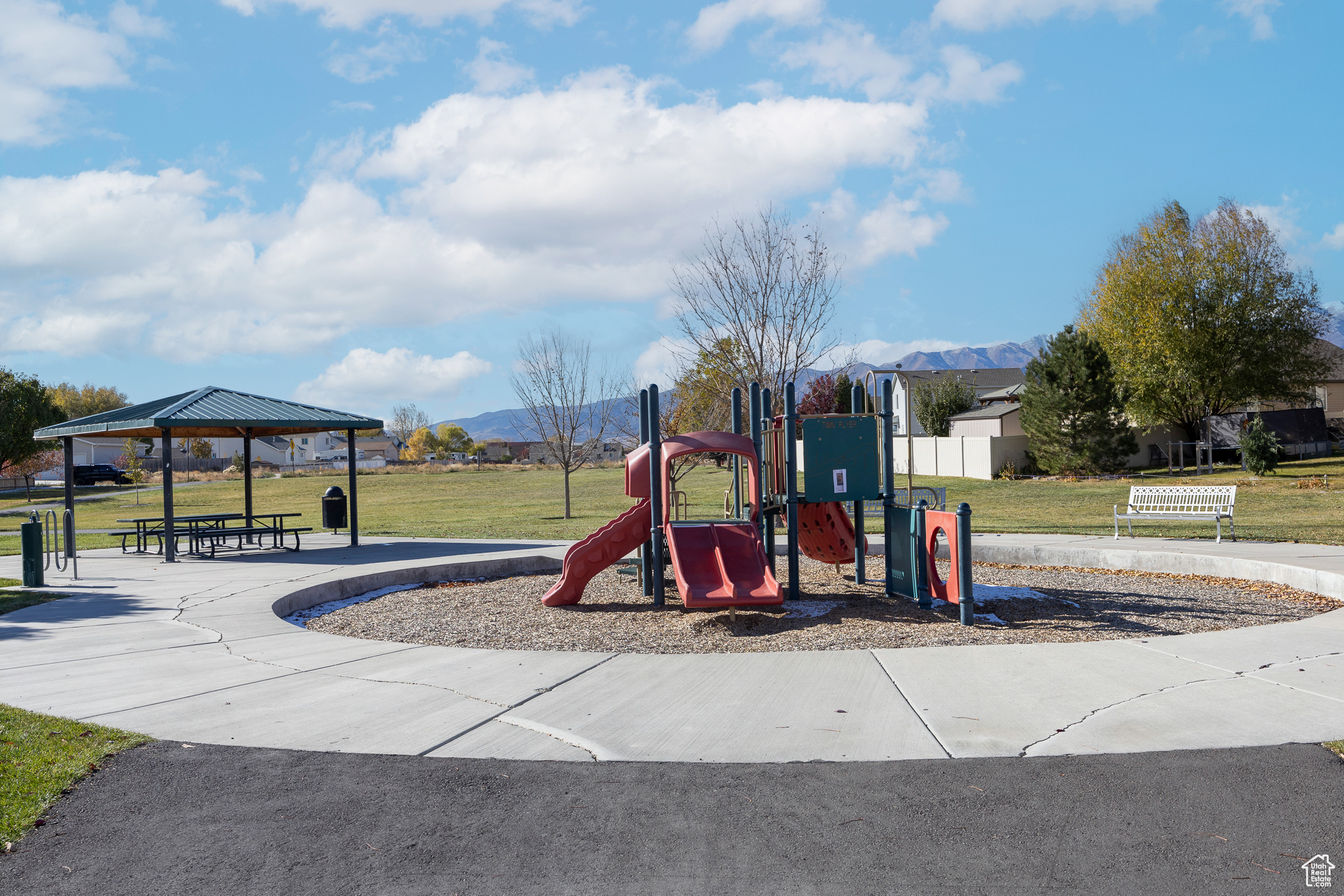 Community jungle gym with a gazebo, a lawn, and a mountain view