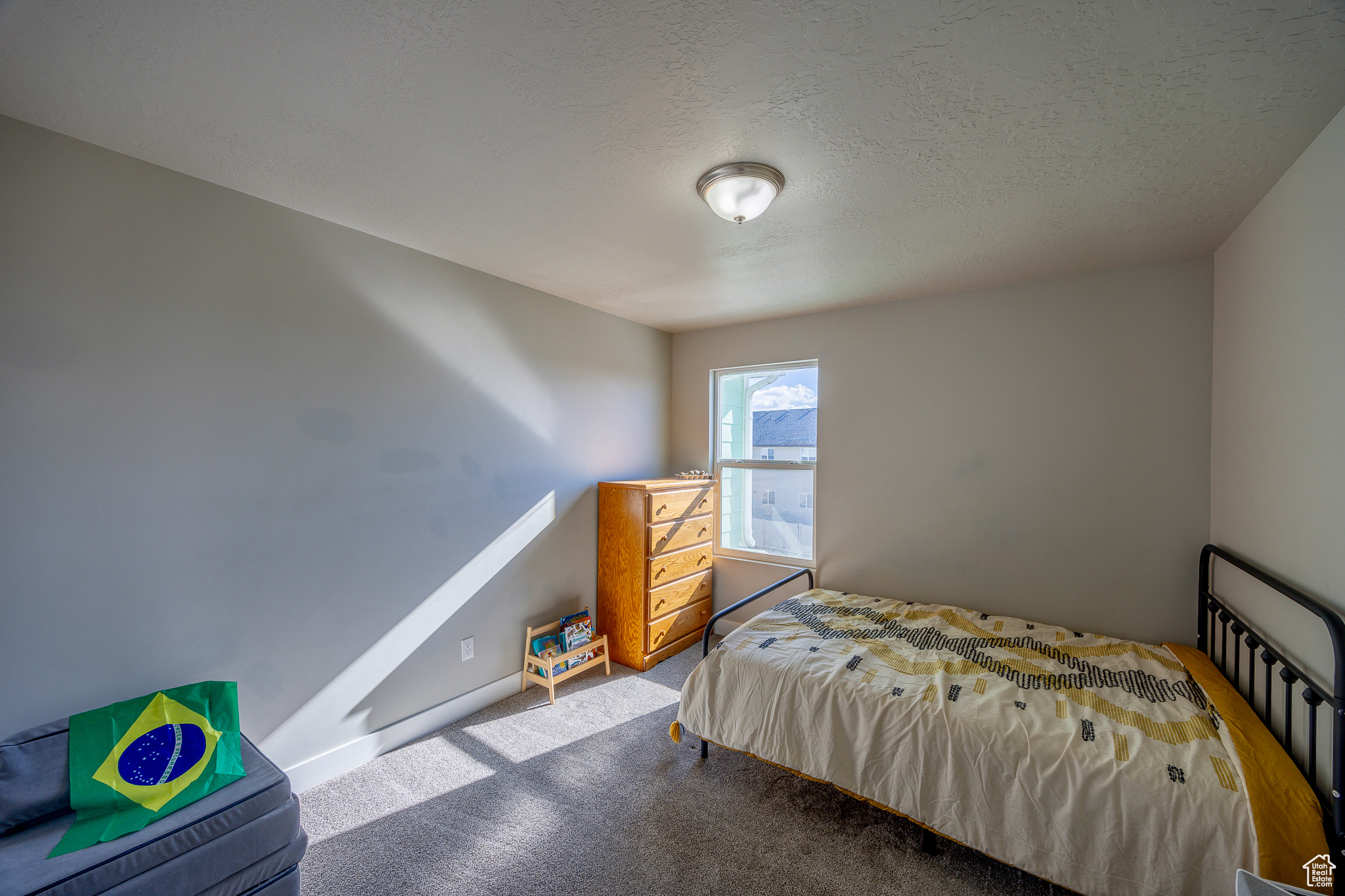 Carpeted bedroom featuring a textured ceiling