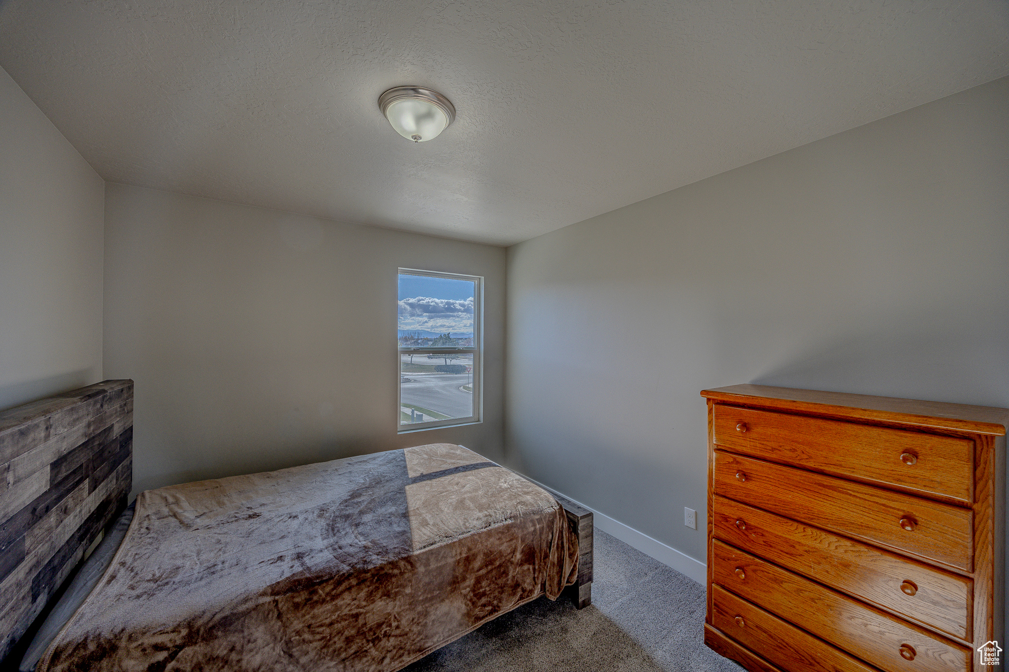 Bedroom featuring baseboards and carpet floors