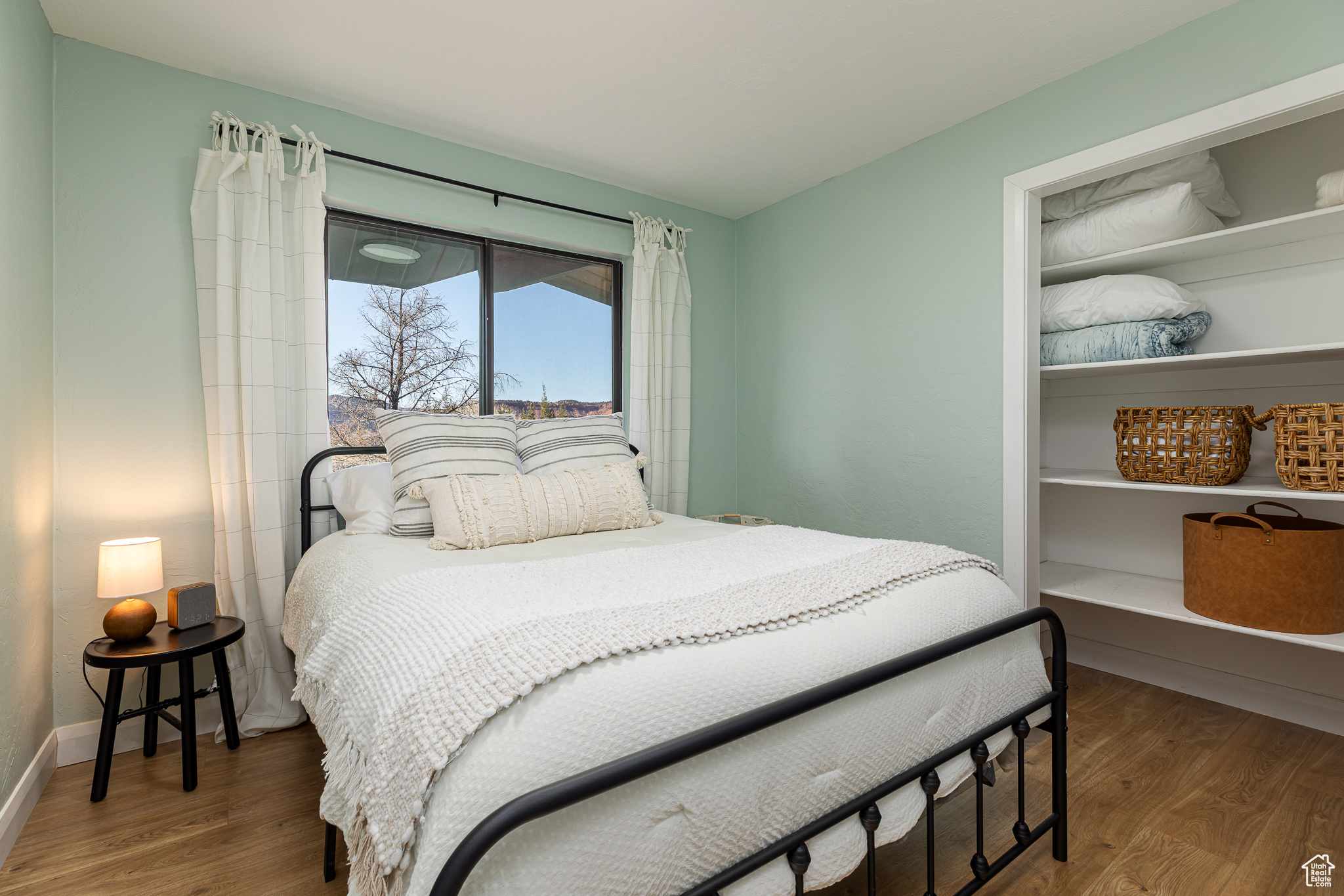 Bedroom featuring baseboards and wood finished floors