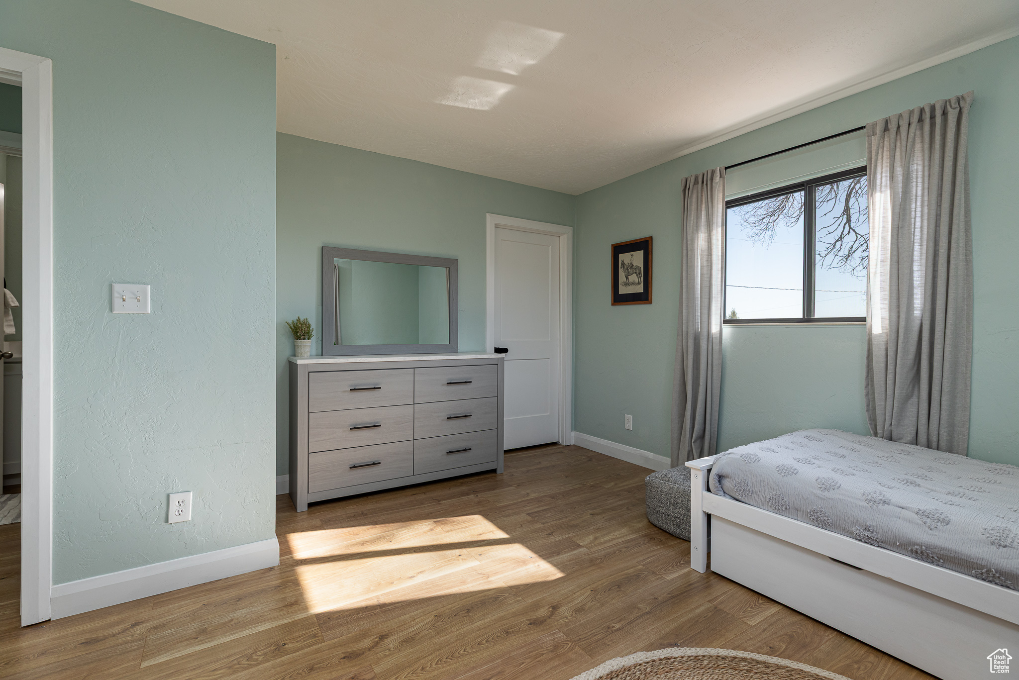 Bedroom with baseboards and wood finished floors