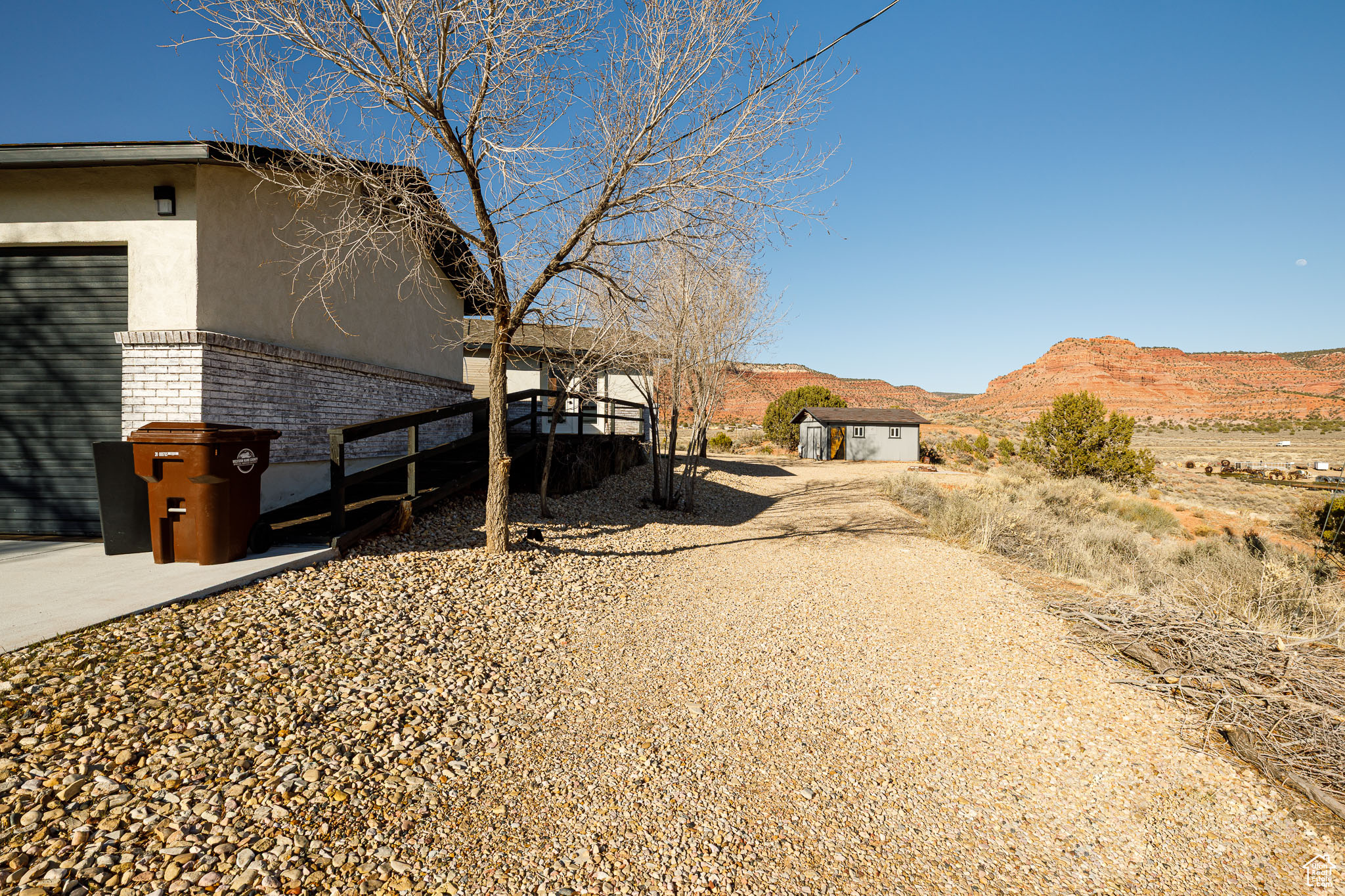 View of yard featuring an outdoor structure, a mountain view, and a shed