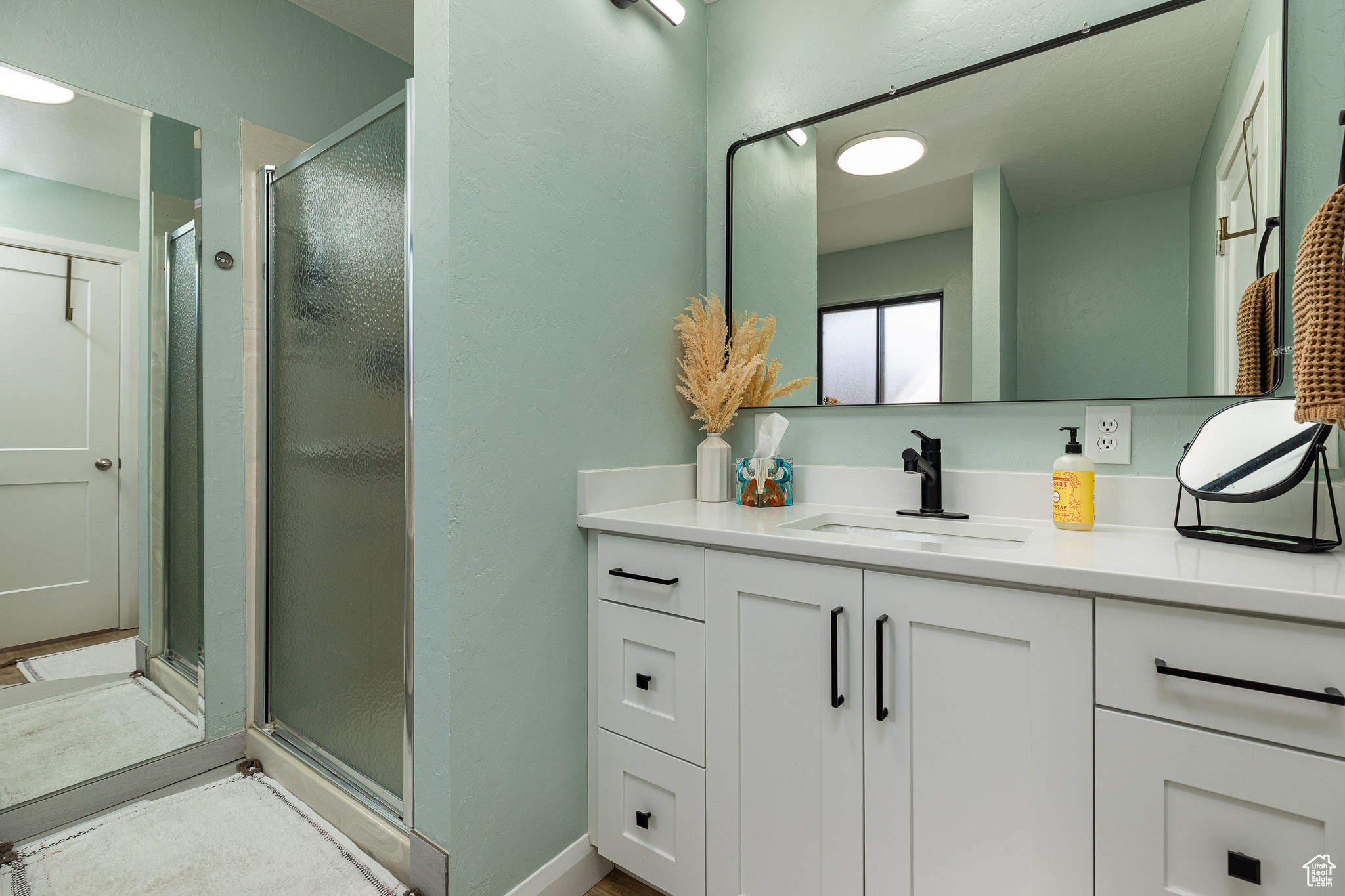 Bathroom with vanity and a shower stall