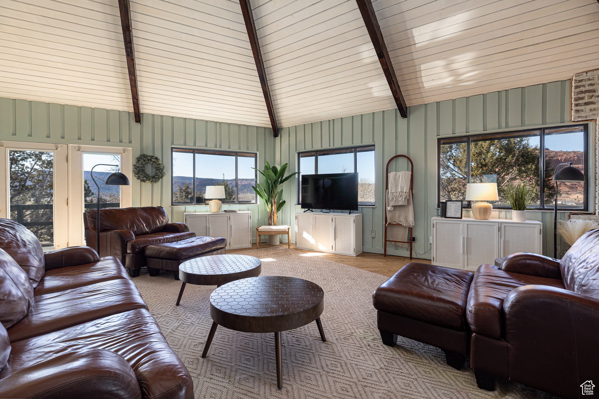 Living room featuring lofted ceiling with beams and wood finished floors