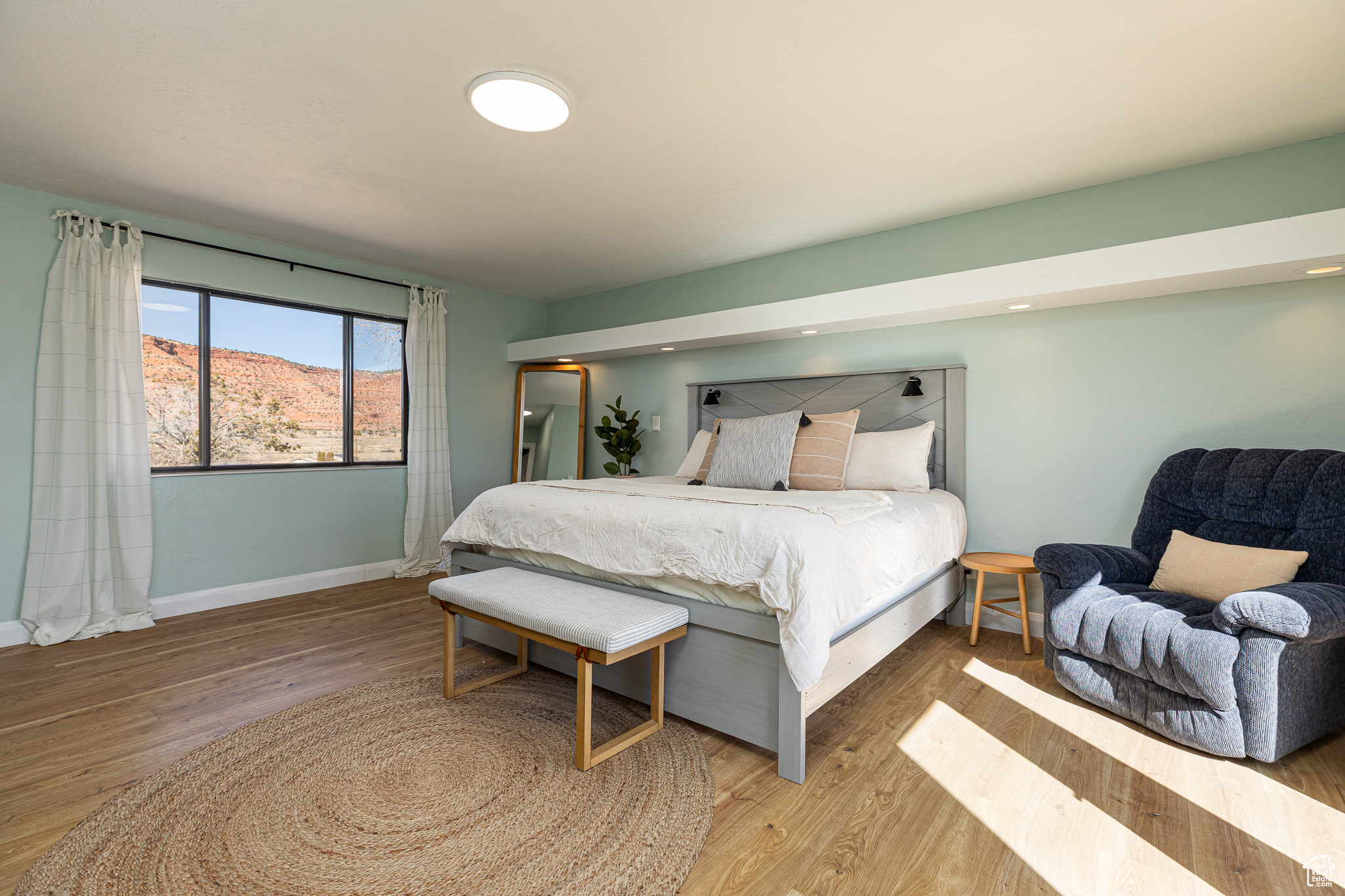 Bedroom with baseboards and wood finished floors