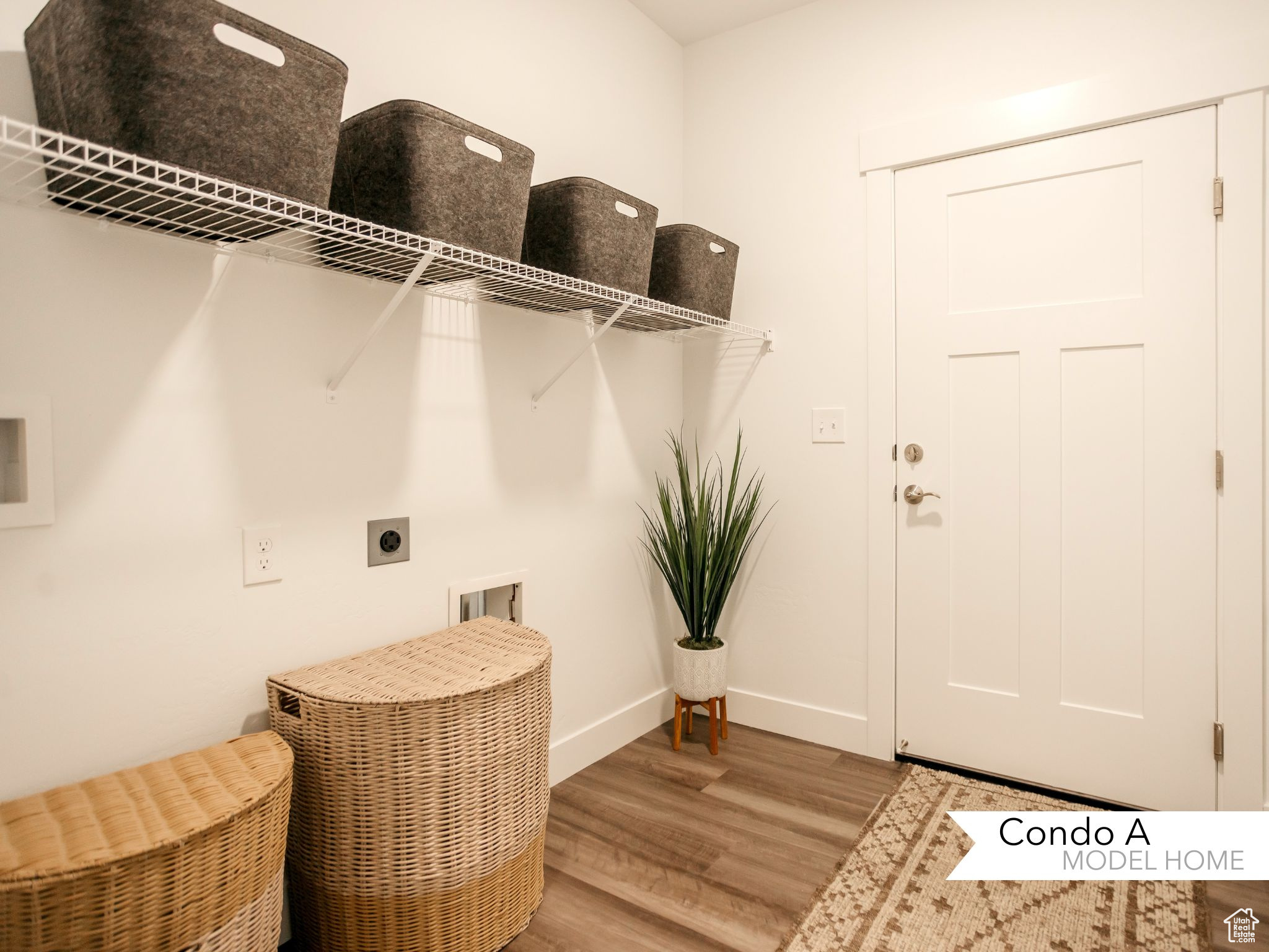 Laundry area featuring laundry area, hookup for an electric dryer, wood finished floors, and washer hookup