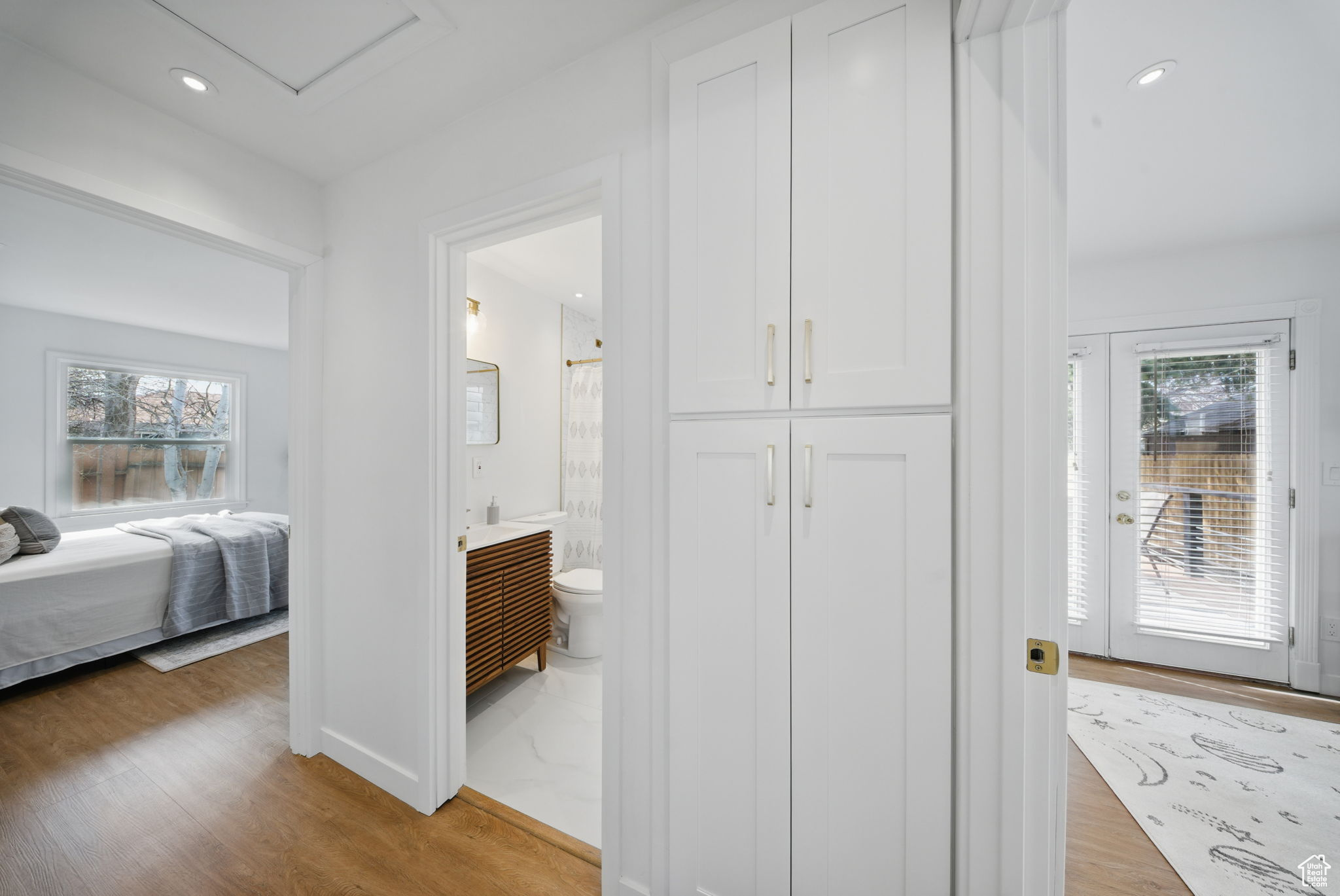 Hallway with light wood-style flooring, recessed lighting, and baseboards