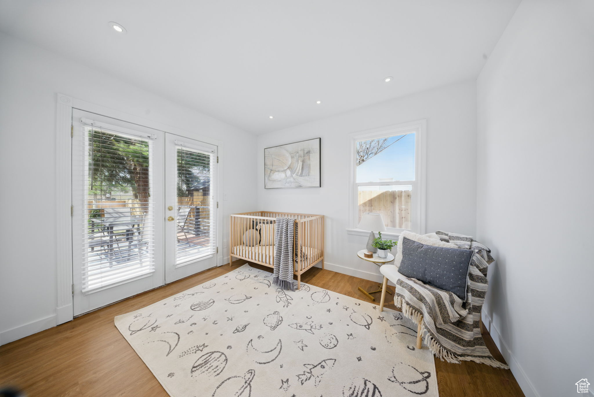 Living area with recessed lighting, french doors, baseboards, and wood finished floors