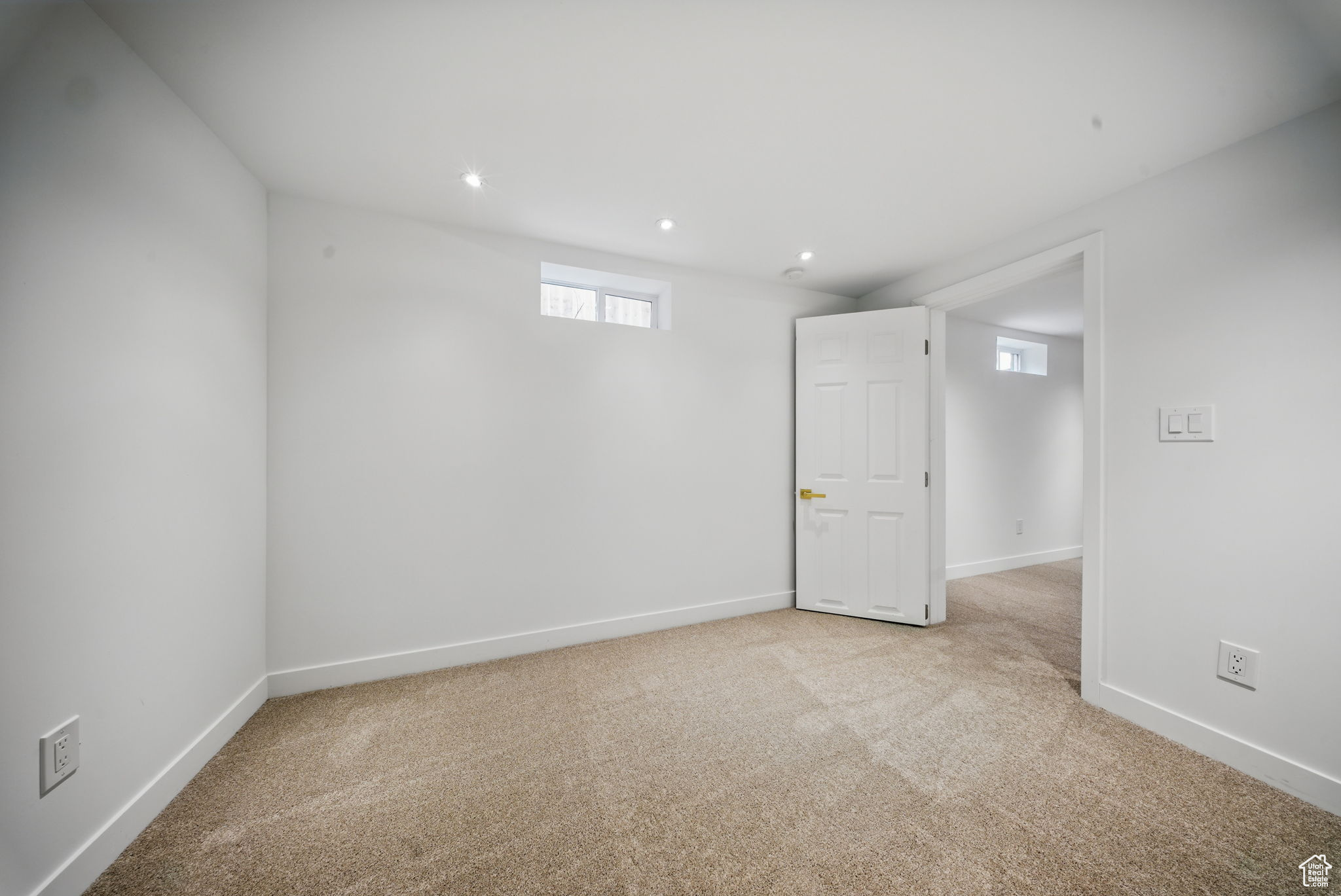 Basement with recessed lighting, light colored carpet, and baseboards