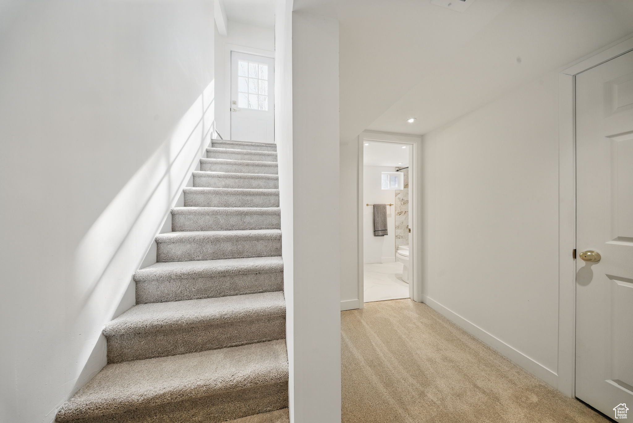 Staircase featuring baseboards and carpet