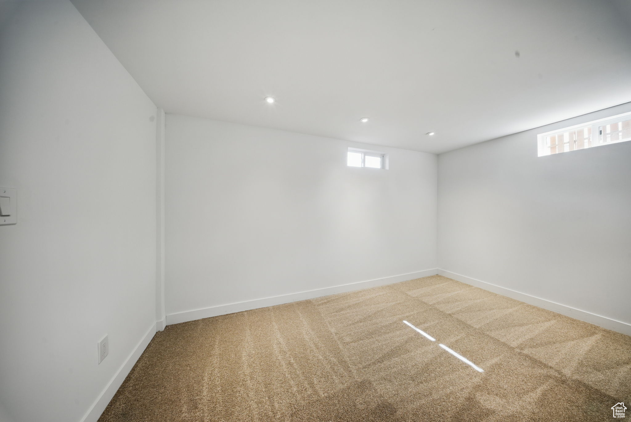 Below grade area featuring recessed lighting, baseboards, and carpet floors