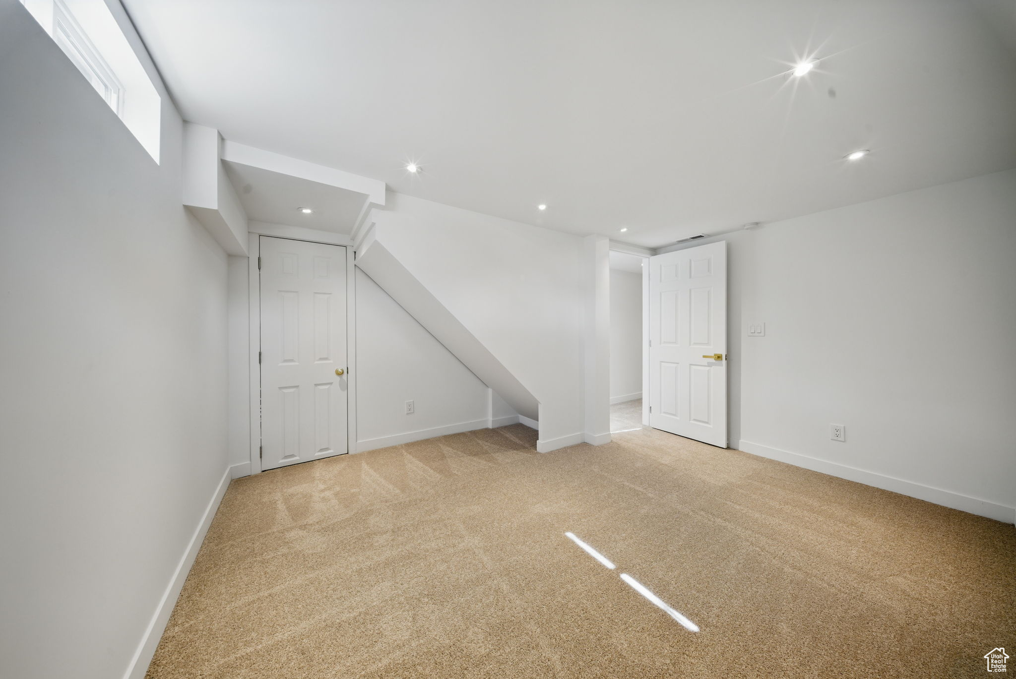 Unfurnished room featuring recessed lighting, baseboards, and light carpet