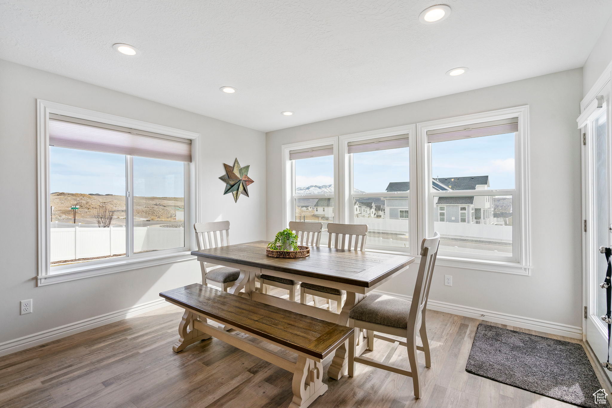 Dining room featuring plenty of natural light, baseboards, and light wood-style floors