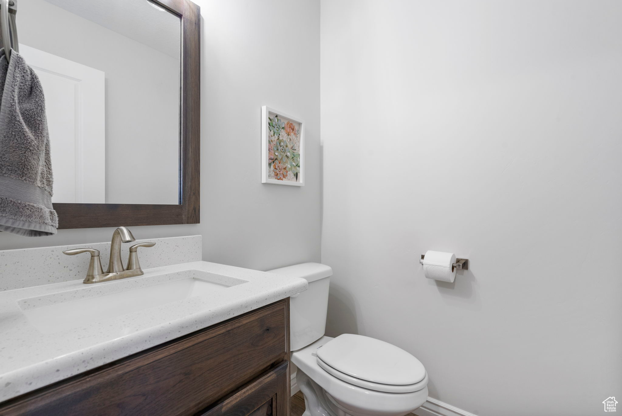 Half bathroom featuring vanity and toilet