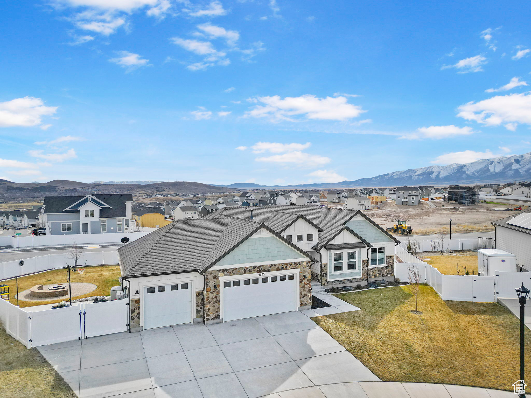 View of front facade with a mountain view, a fenced backyard, and a gate