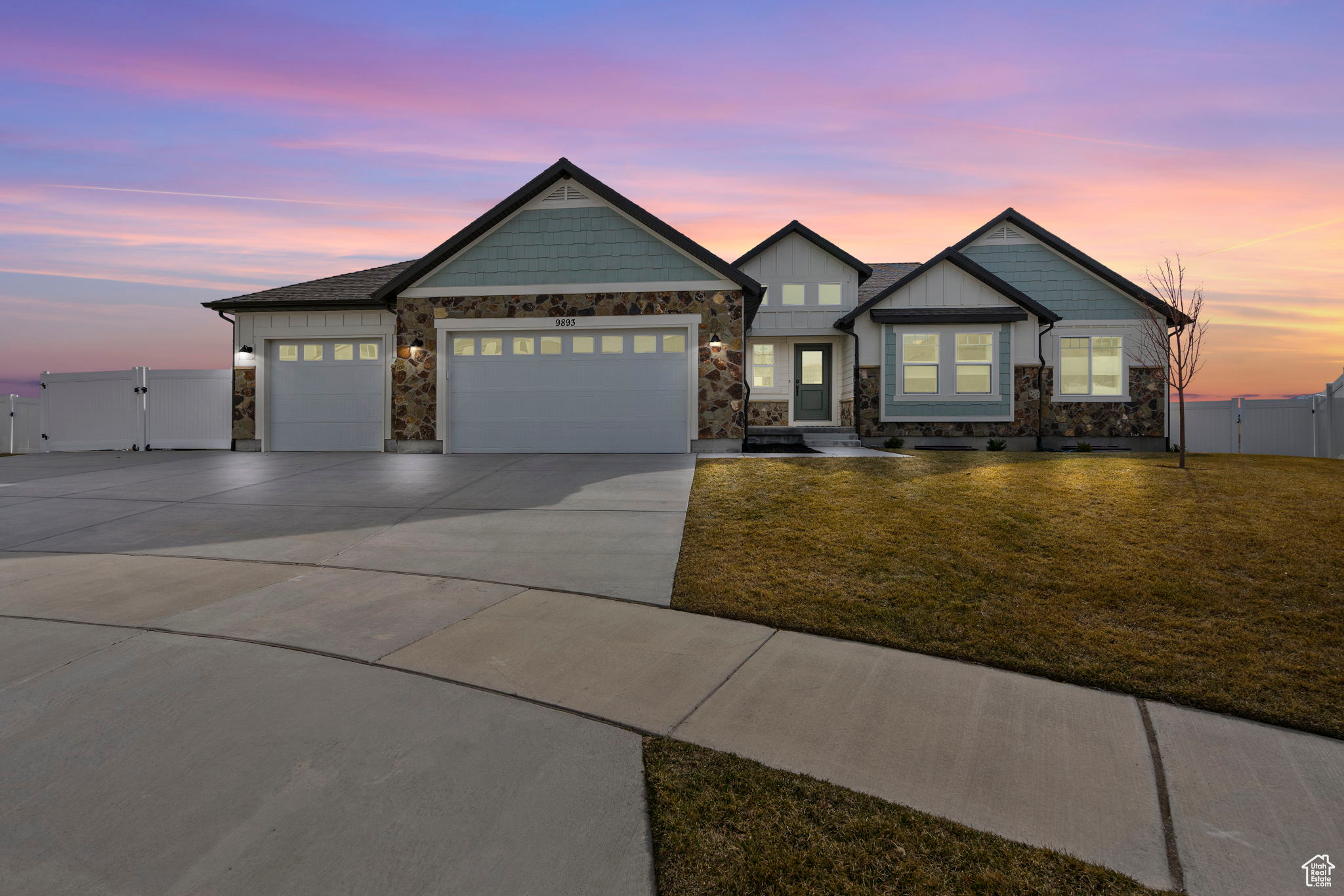 Craftsman house with an attached garage, a gate, a front yard, and driveway