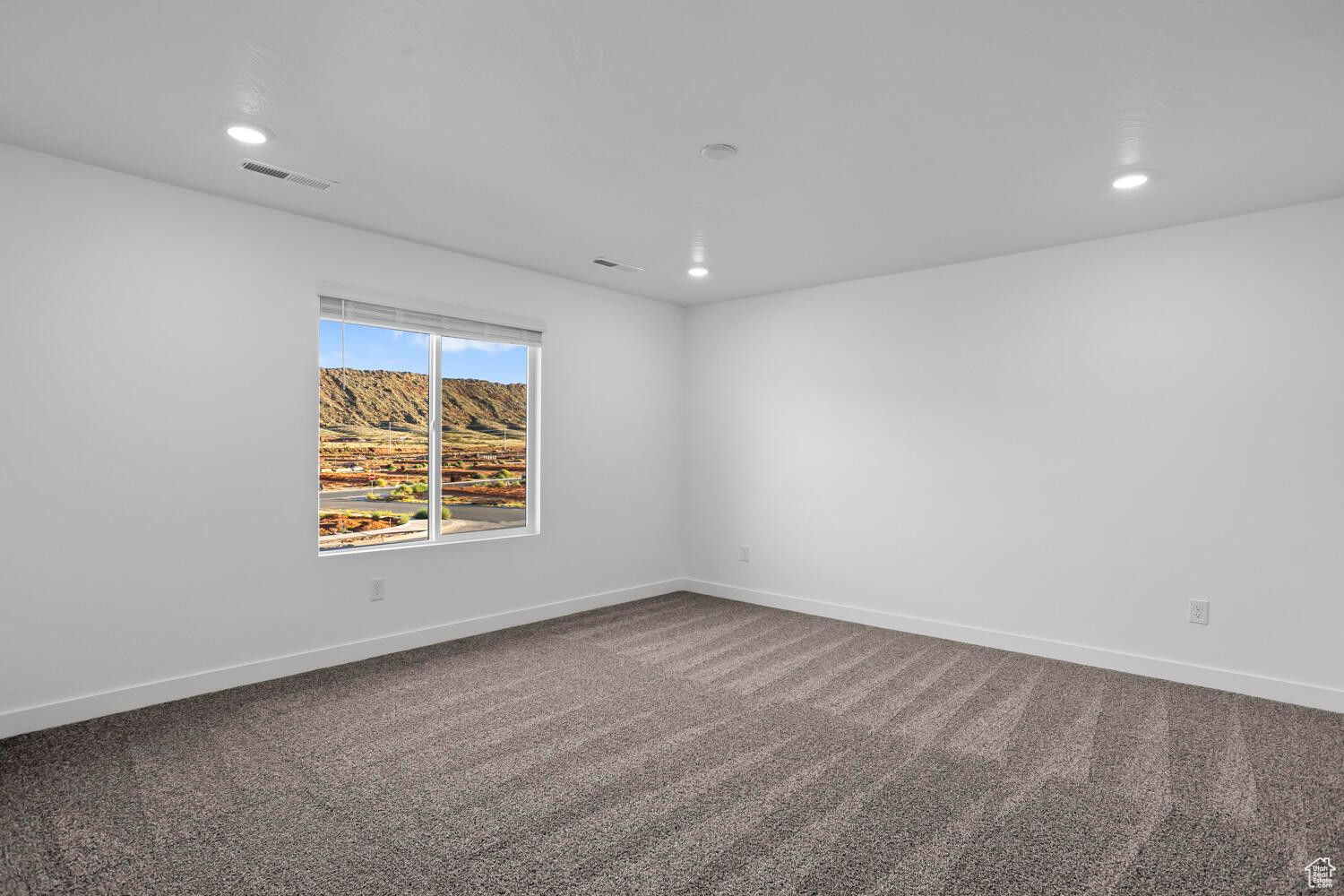 Spare room featuring recessed lighting, visible vents, carpet flooring, and baseboards