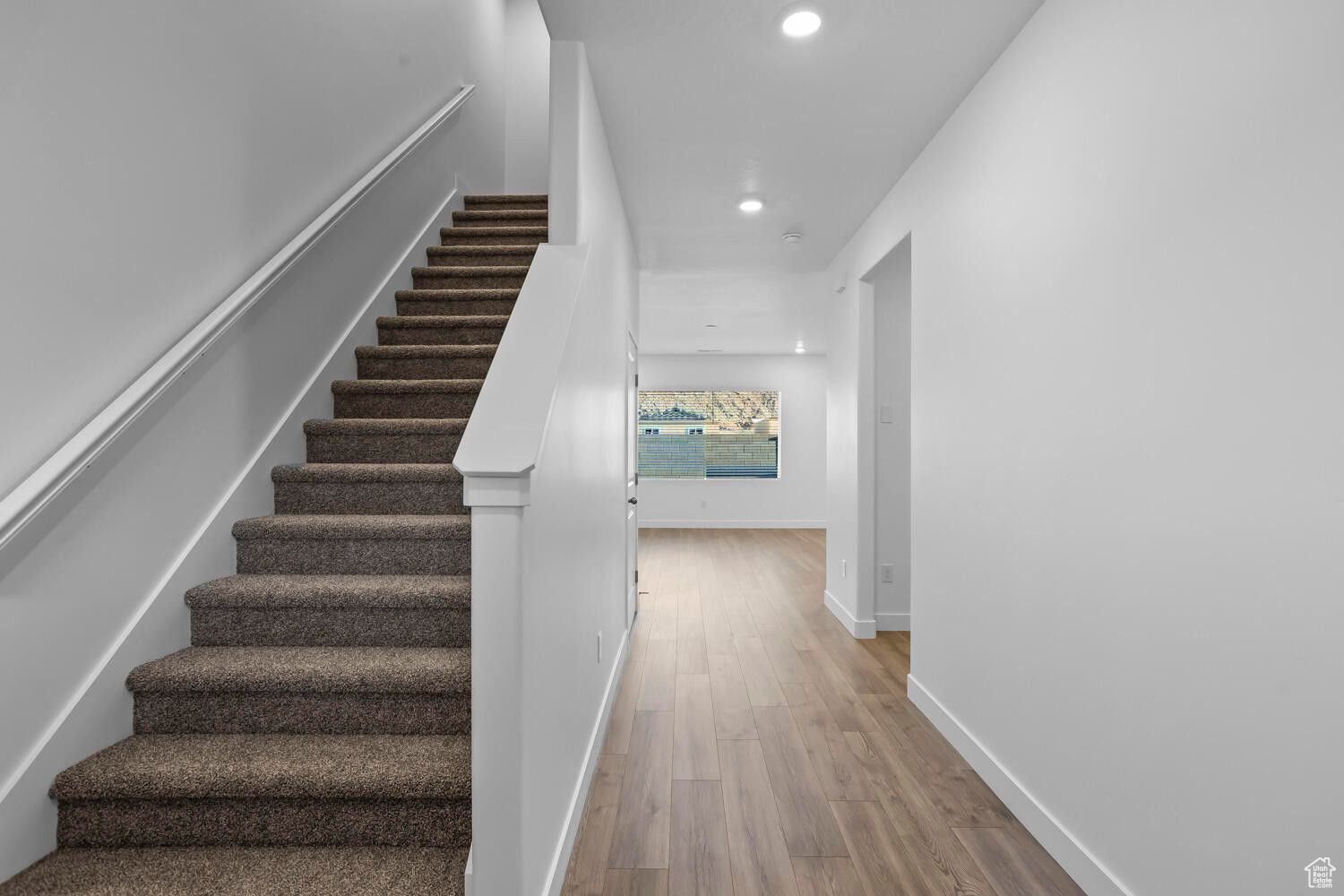 Stairway featuring recessed lighting, baseboards, and wood finished floors