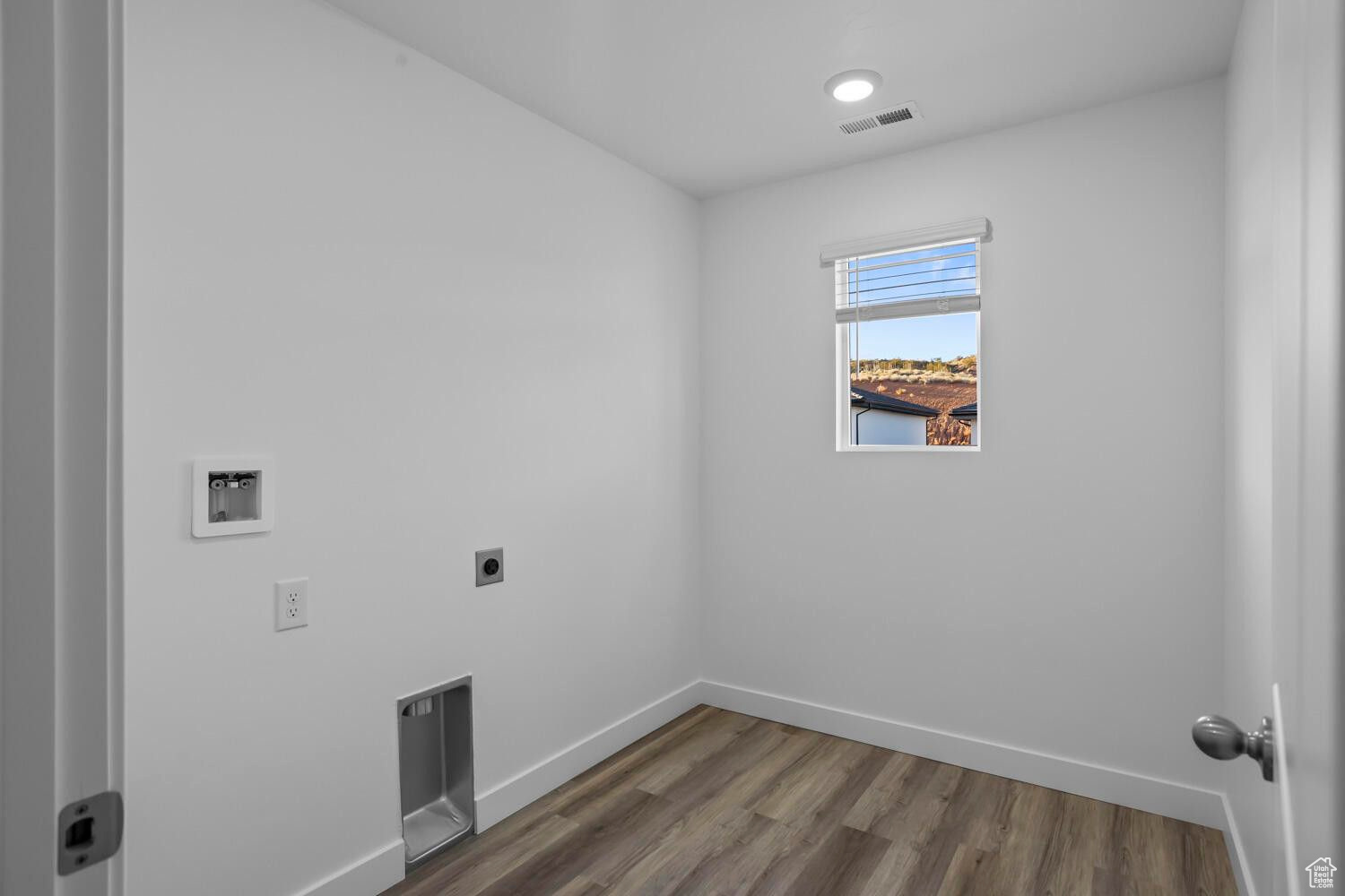 Laundry area featuring visible vents, dark wood-type flooring, baseboards, hookup for an electric dryer, and laundry area