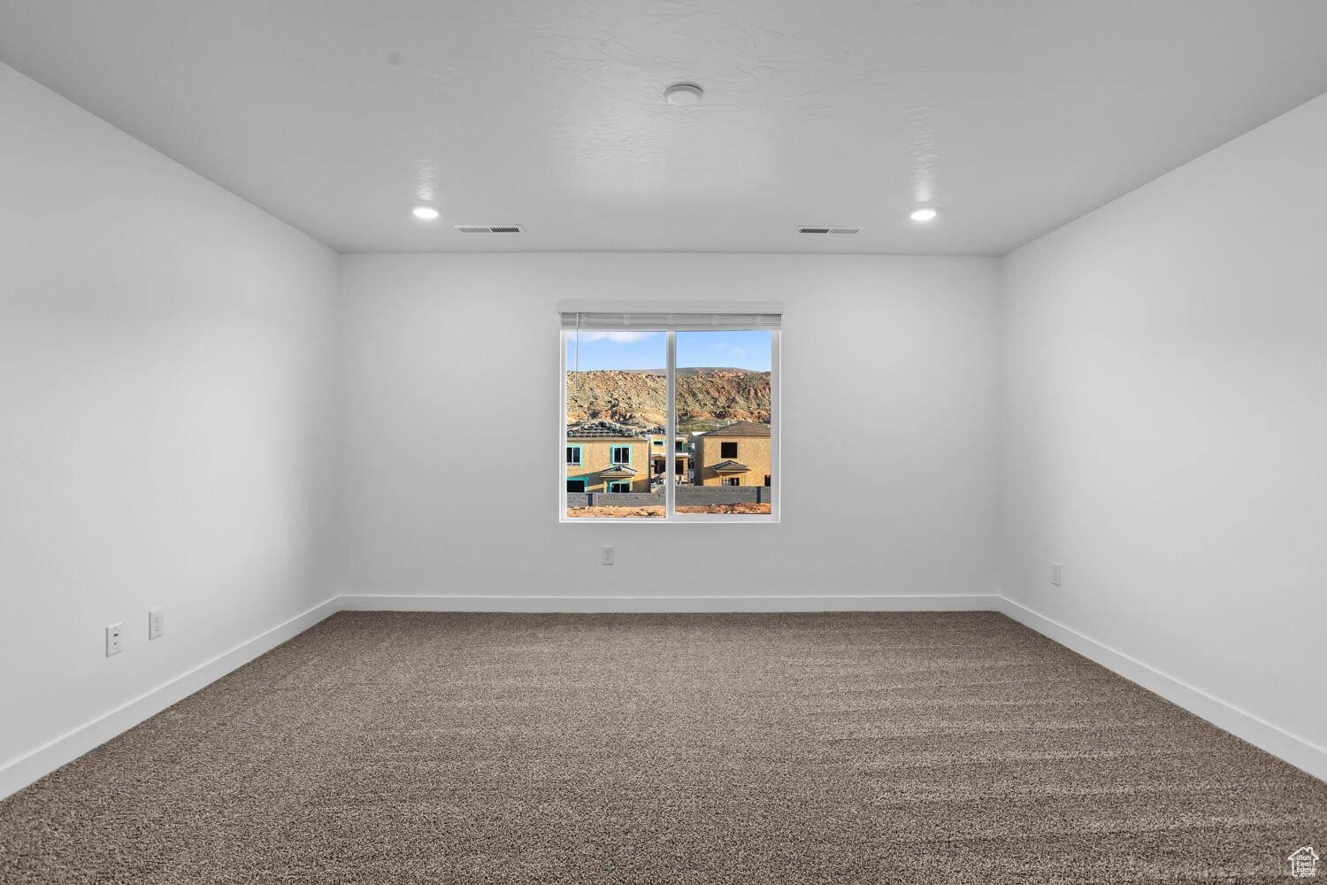 Empty room with carpet flooring, recessed lighting, and baseboards