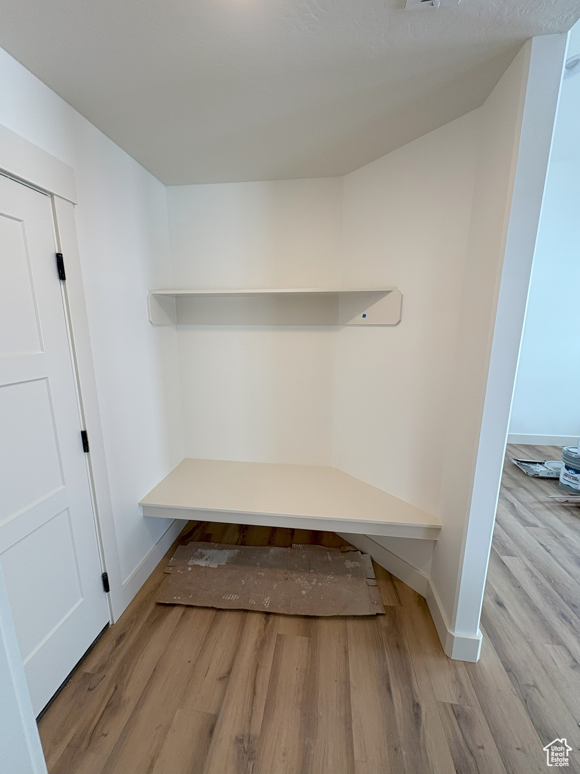 Mudroom featuring wood finished floors and baseboards