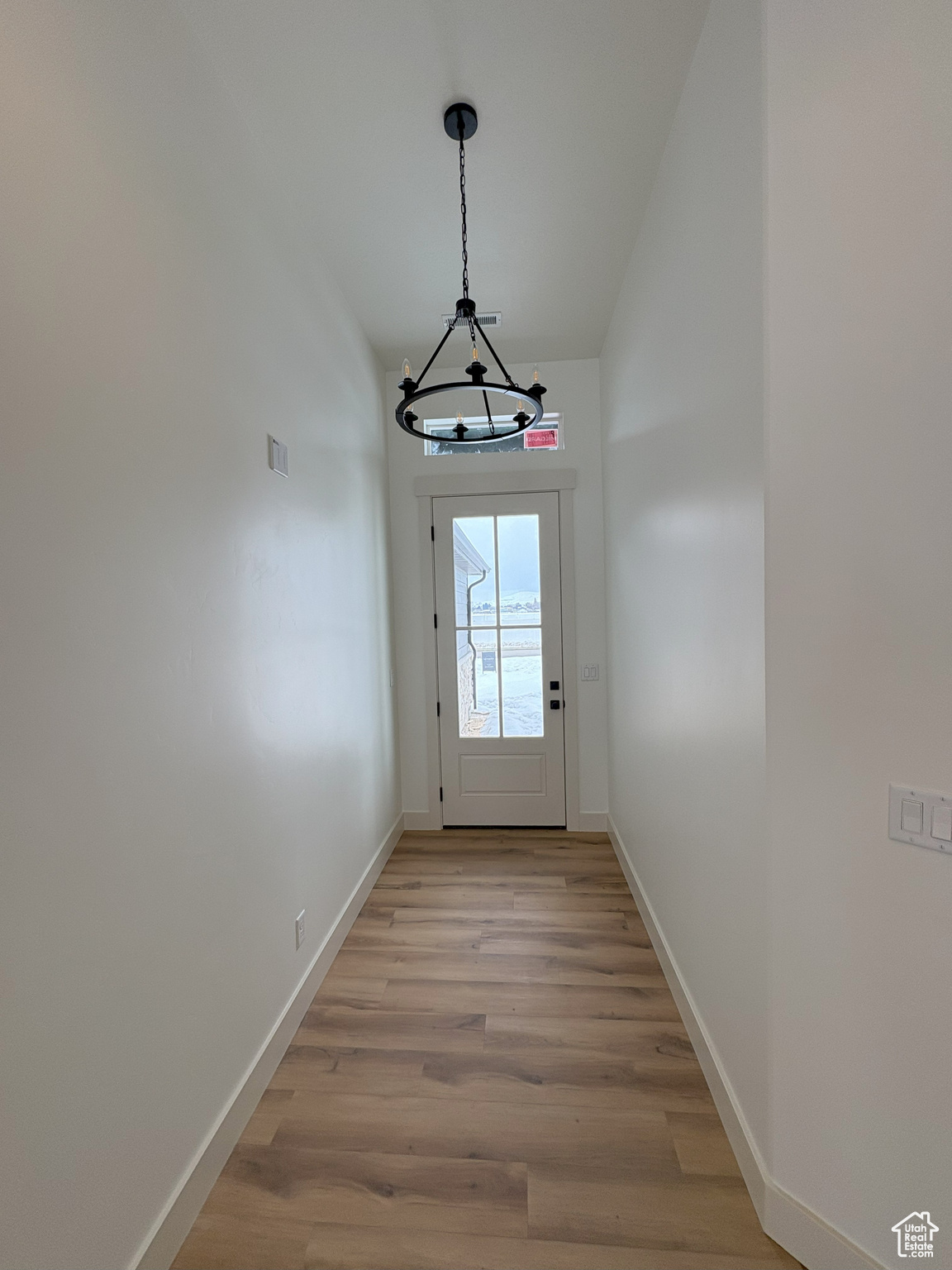 Entryway with light wood-style flooring and baseboards