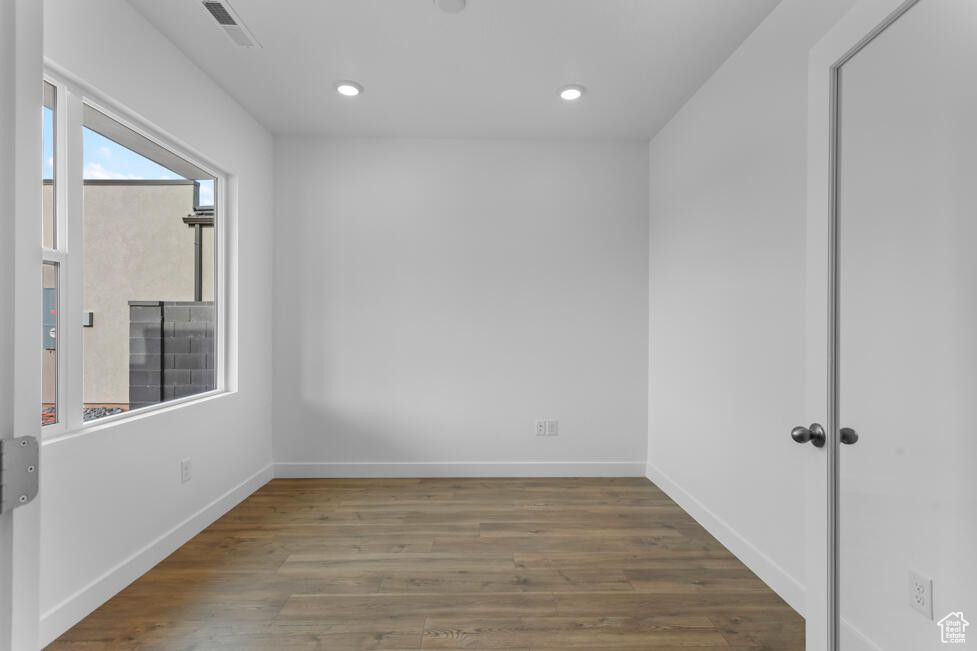 Spare room featuring visible vents, recessed lighting, wood finished floors, and baseboards