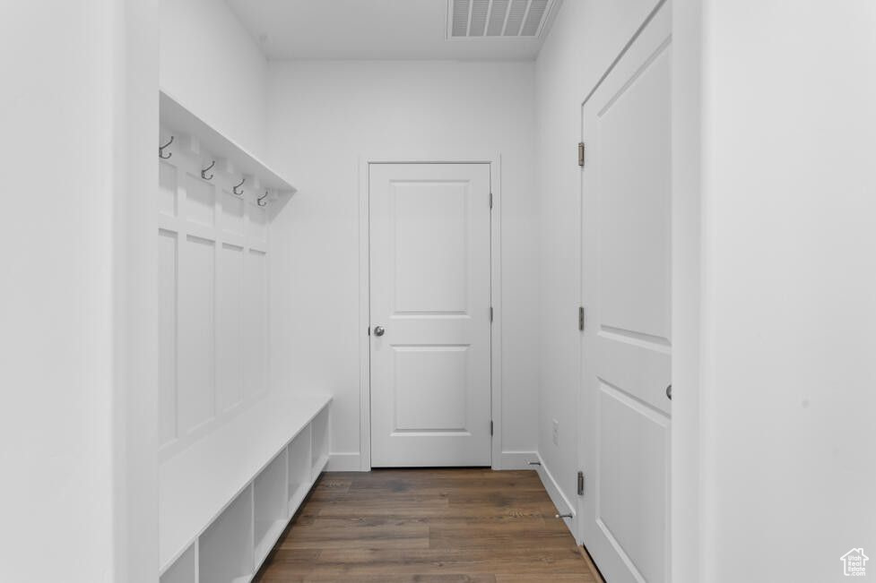 Mudroom featuring dark wood finished floors and visible vents