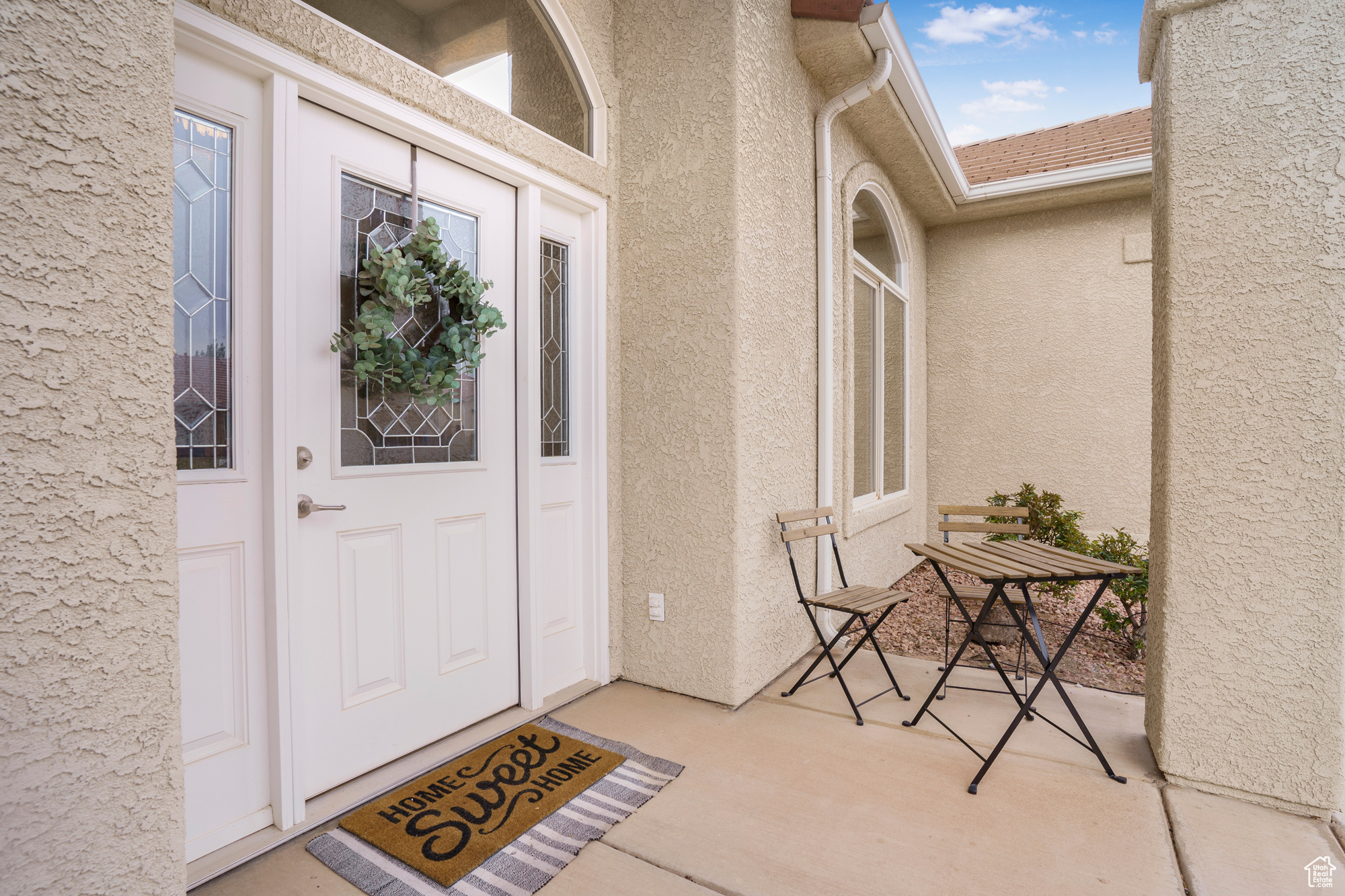 Property entrance featuring stucco siding