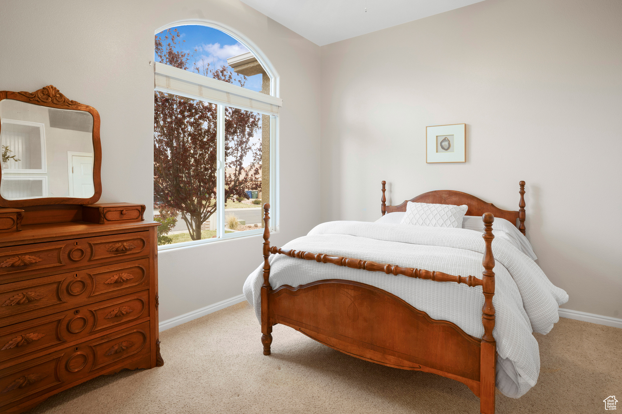 Bedroom with baseboards and light carpet