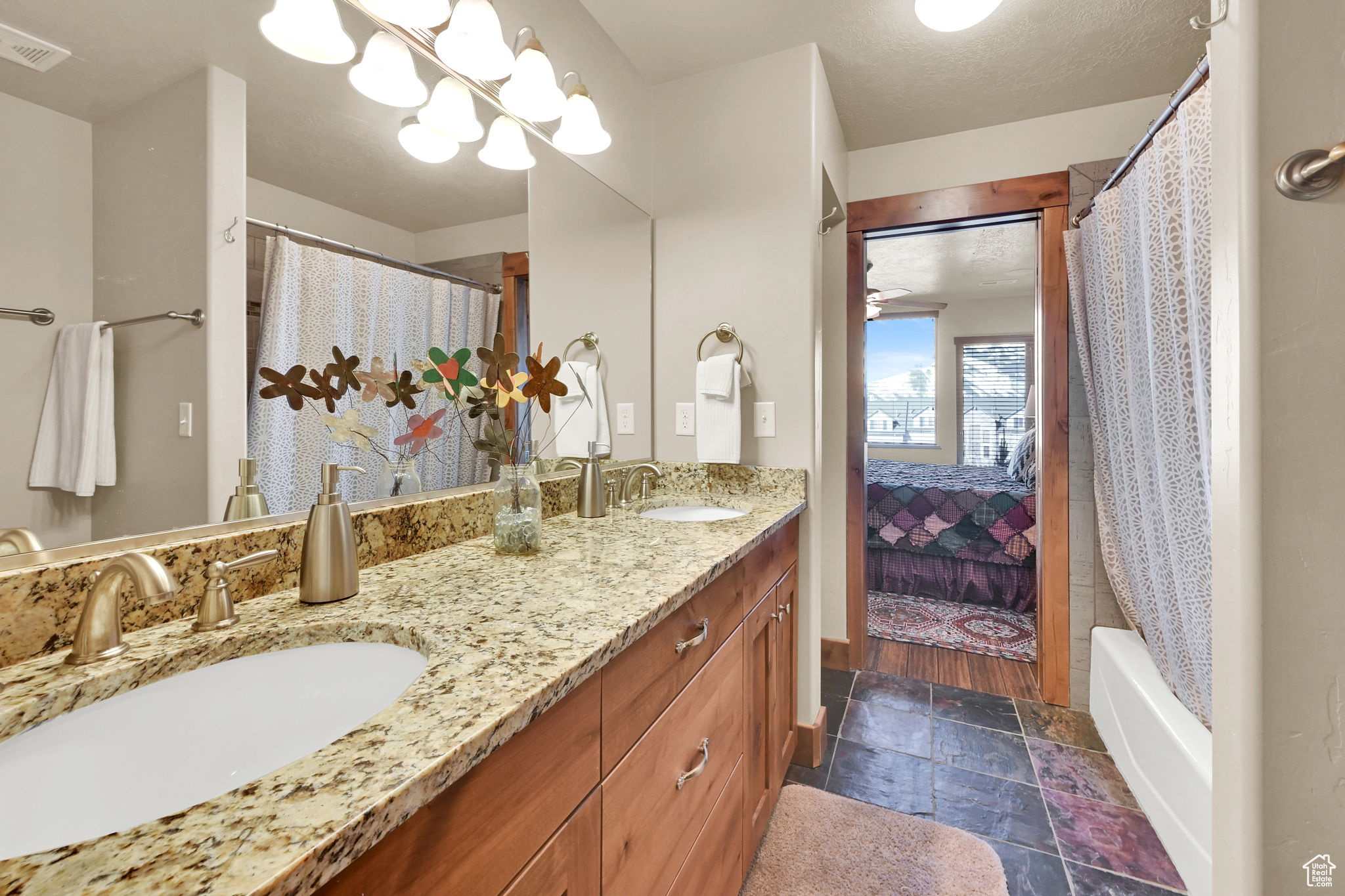 Ensuite bathroom featuring a sink, visible vents, ensuite bath, and double vanity