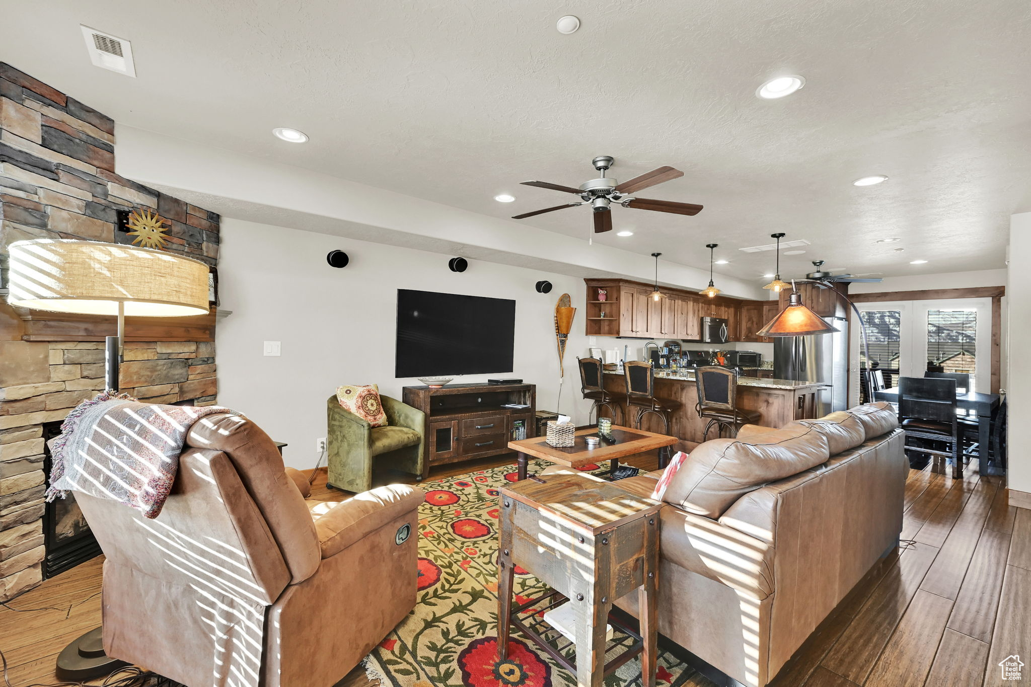 Living room featuring recessed lighting, visible vents, ceiling fan, and light wood finished floors