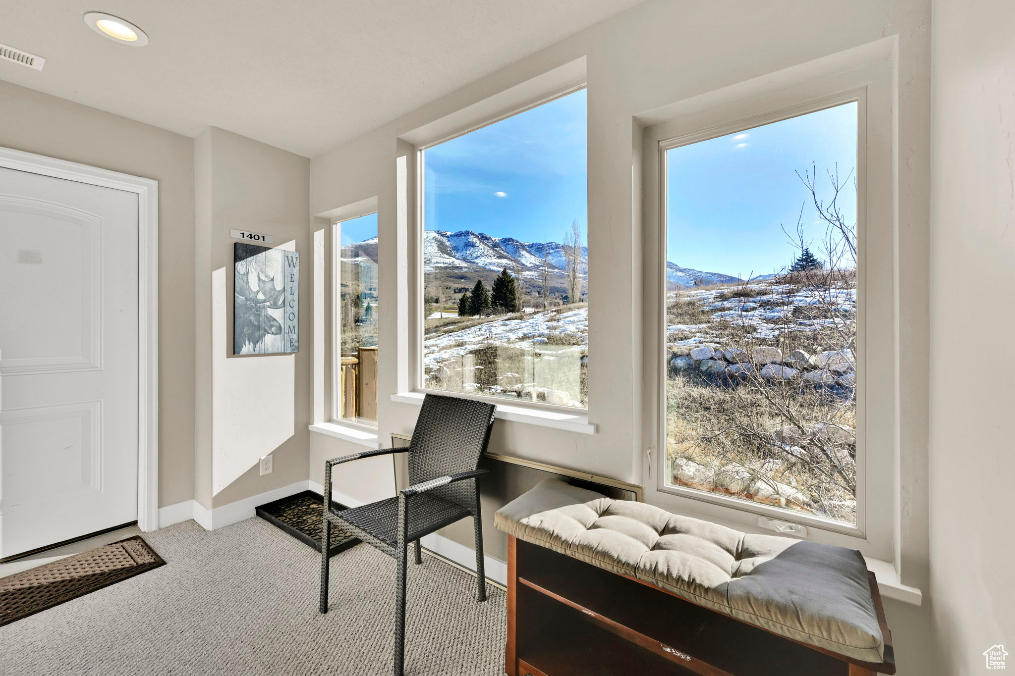 Living area featuring carpet, visible vents, baseboards, recessed lighting, and a mountain view