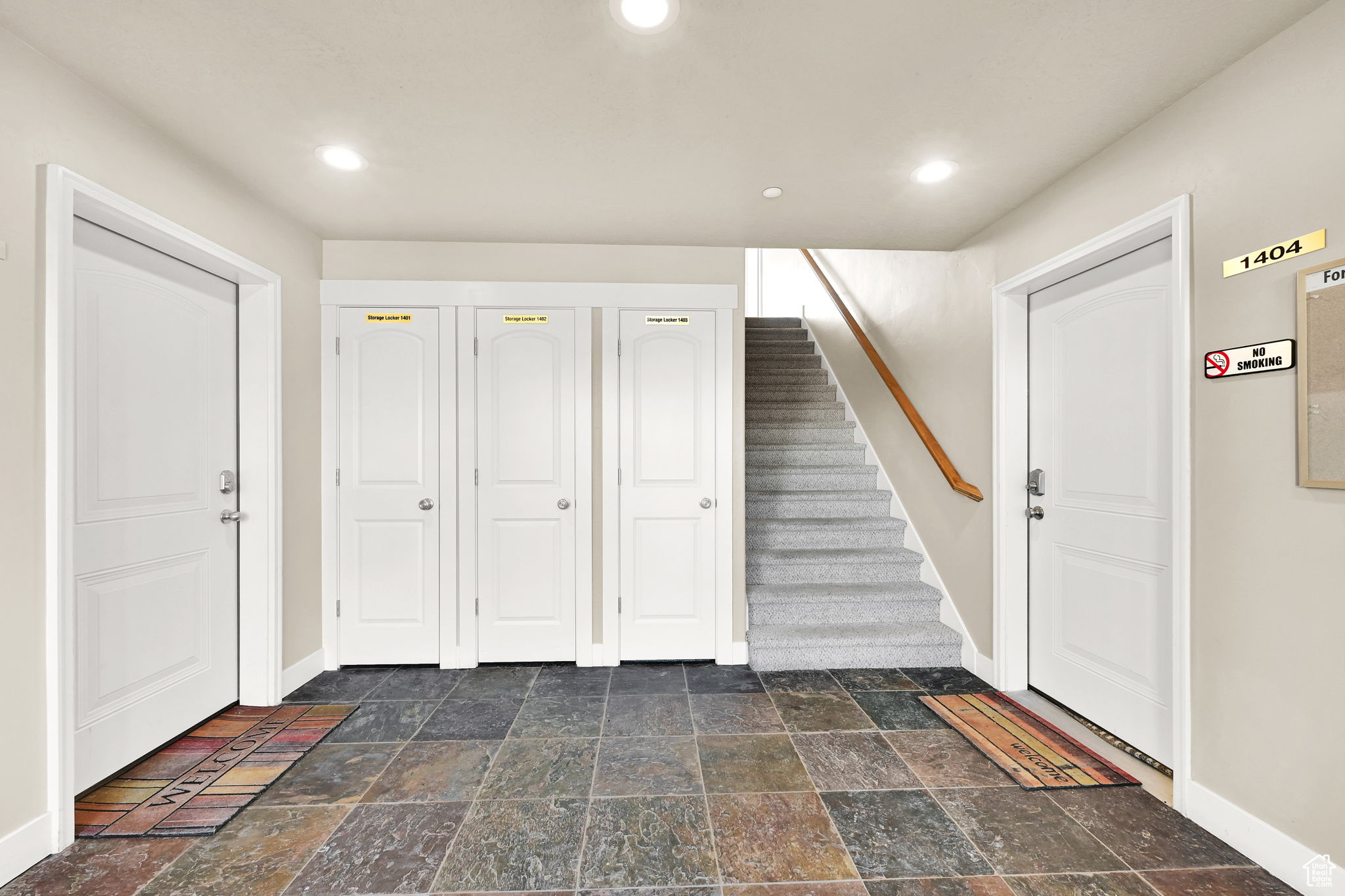 Foyer with stairway, recessed lighting, baseboards, and stone tile flooring