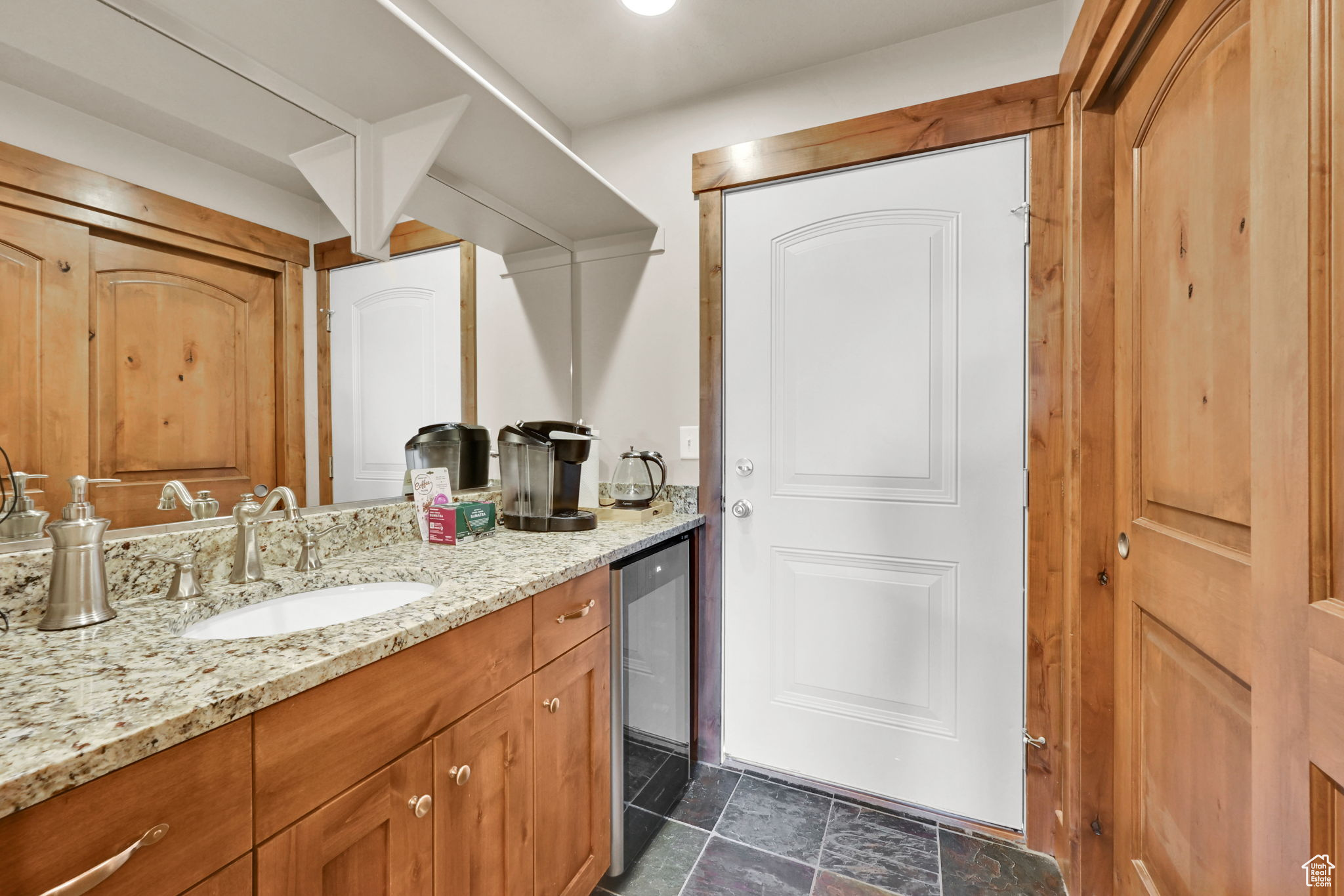 Bathroom featuring vanity and stone finish floor