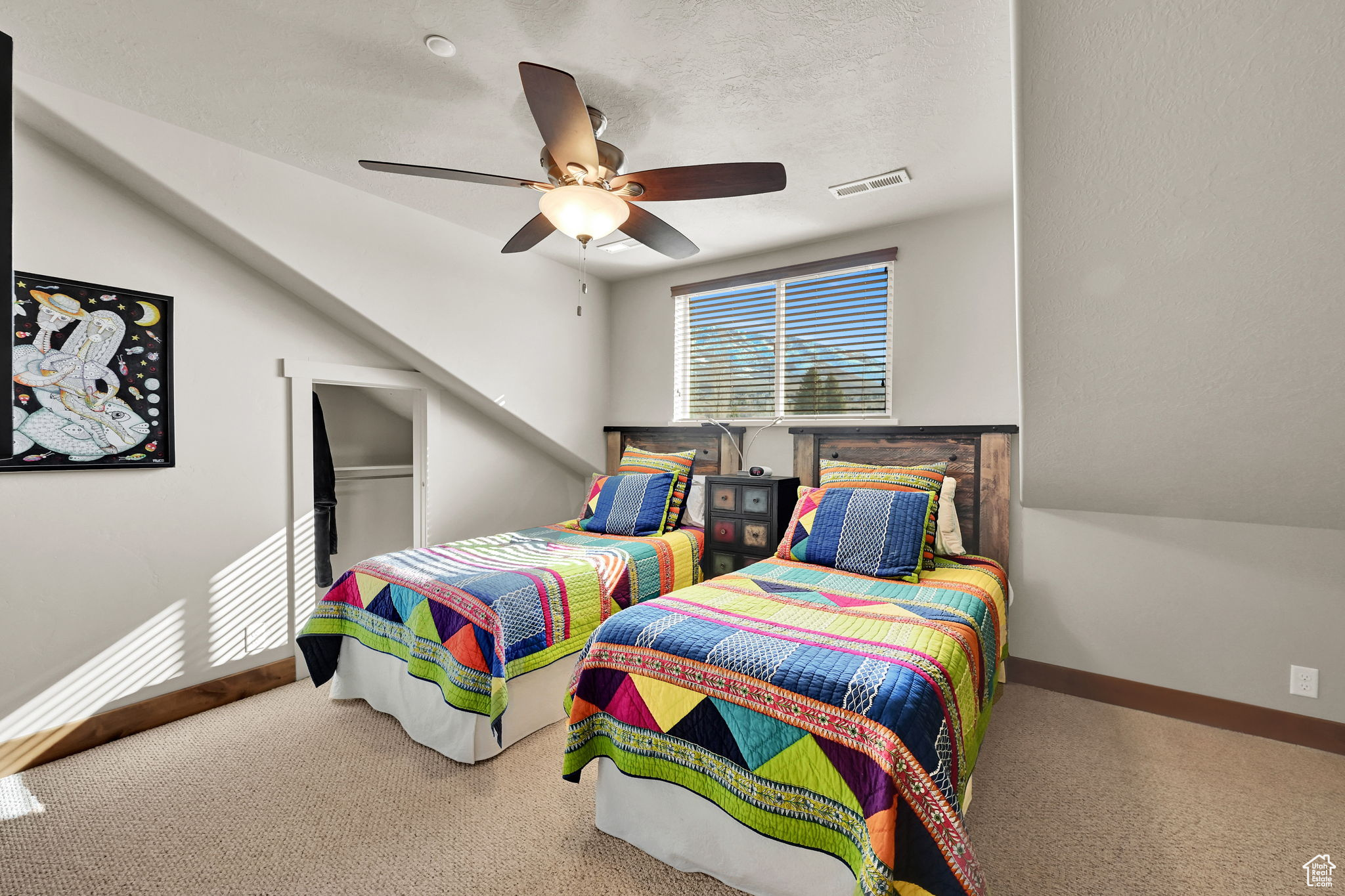 Bedroom featuring a ceiling fan, baseboards, visible vents, a textured ceiling, and carpet flooring