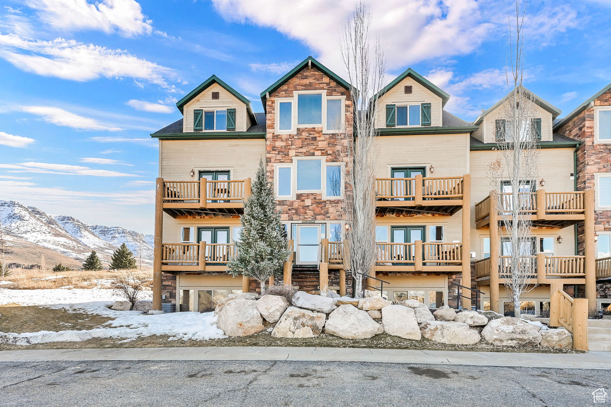 View of front of house with a mountain view and stone siding