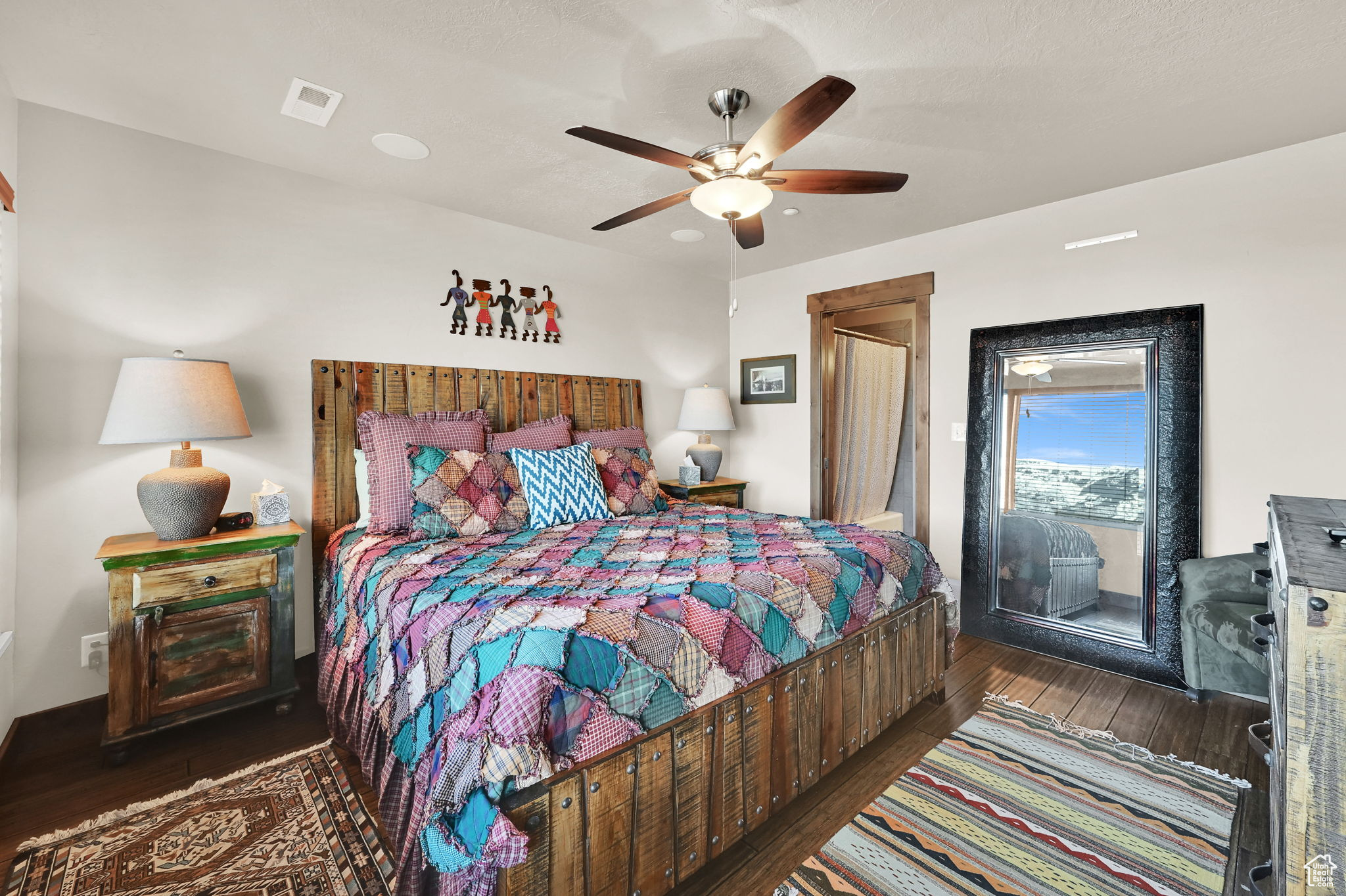 Bedroom featuring visible vents, wood-type flooring, ceiling fan, and access to outside