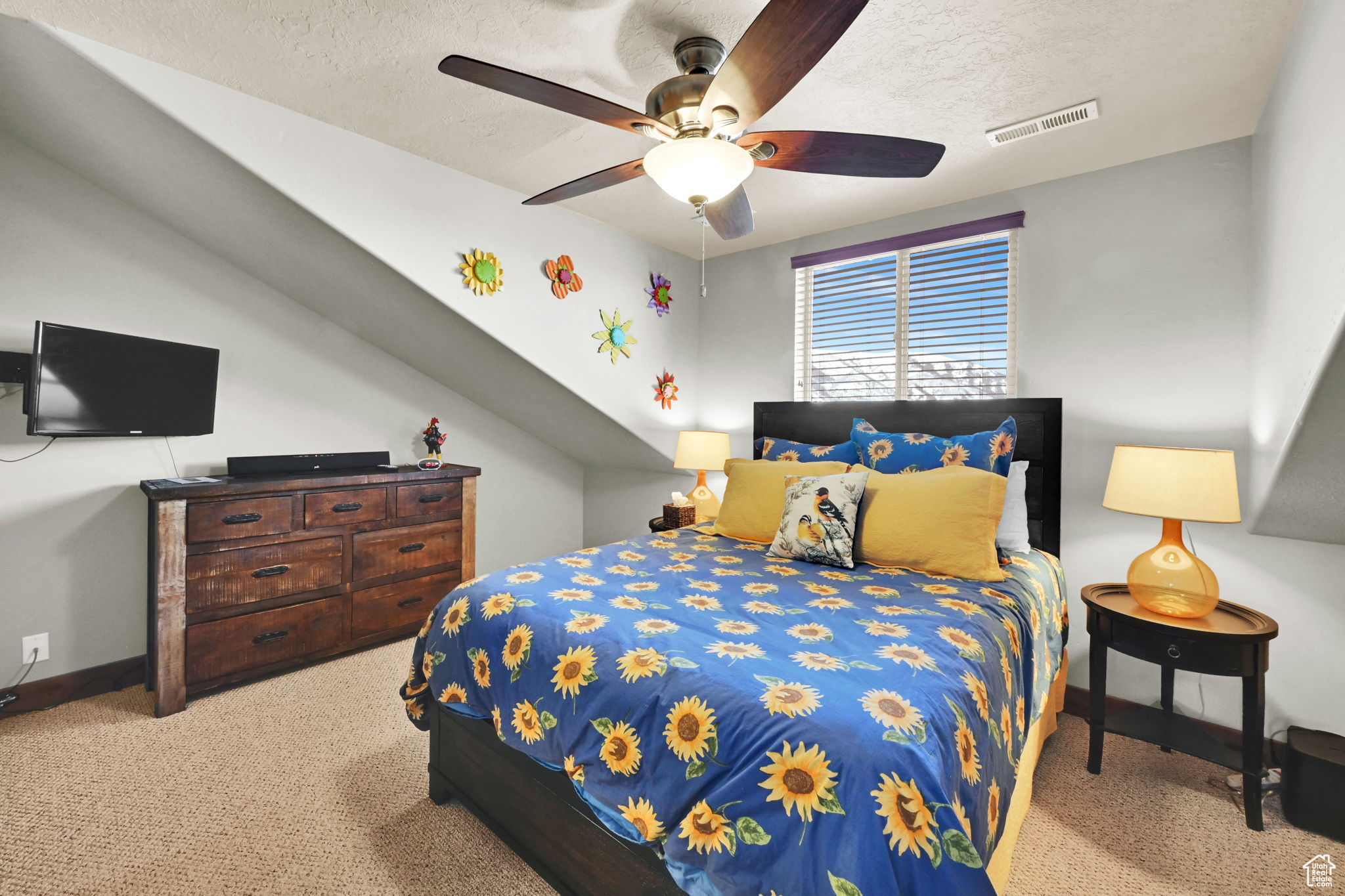 Bedroom with baseboards, visible vents, ceiling fan, a textured ceiling, and carpet flooring