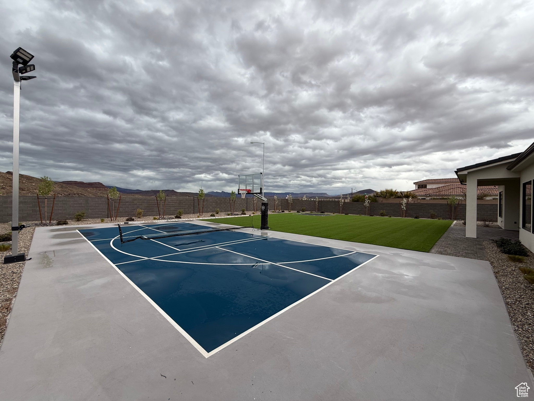 View of basketball court featuring community basketball court, fence private yard, and a yard