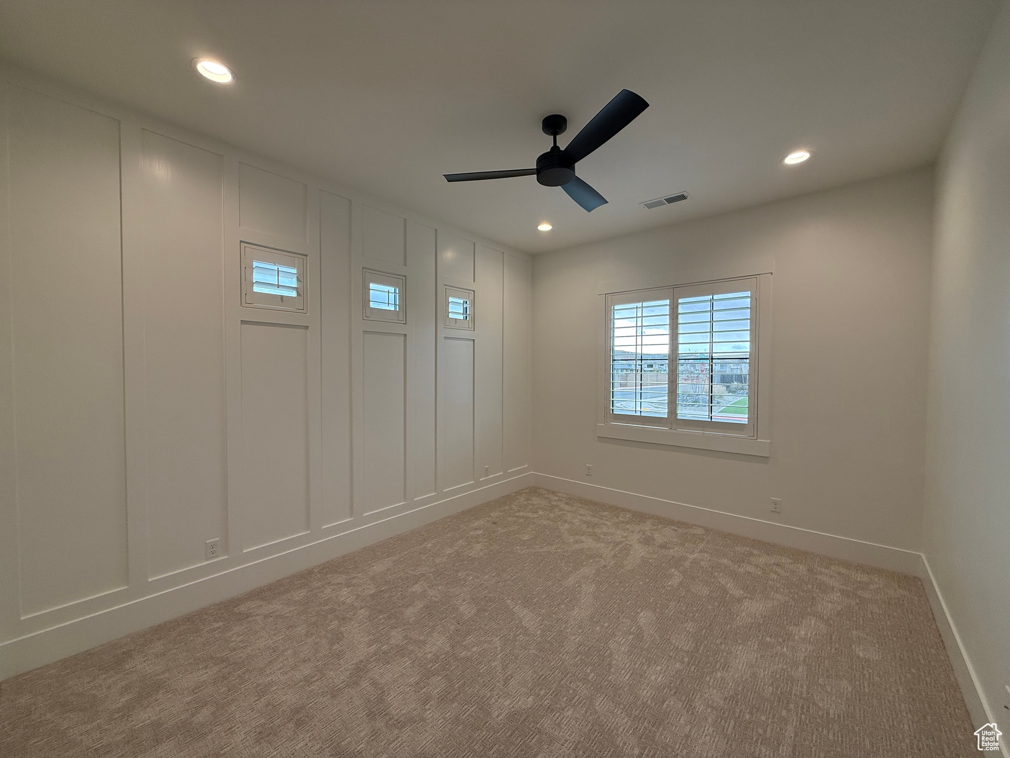 Spare room with light carpet, recessed lighting, baseboards, and a ceiling fan