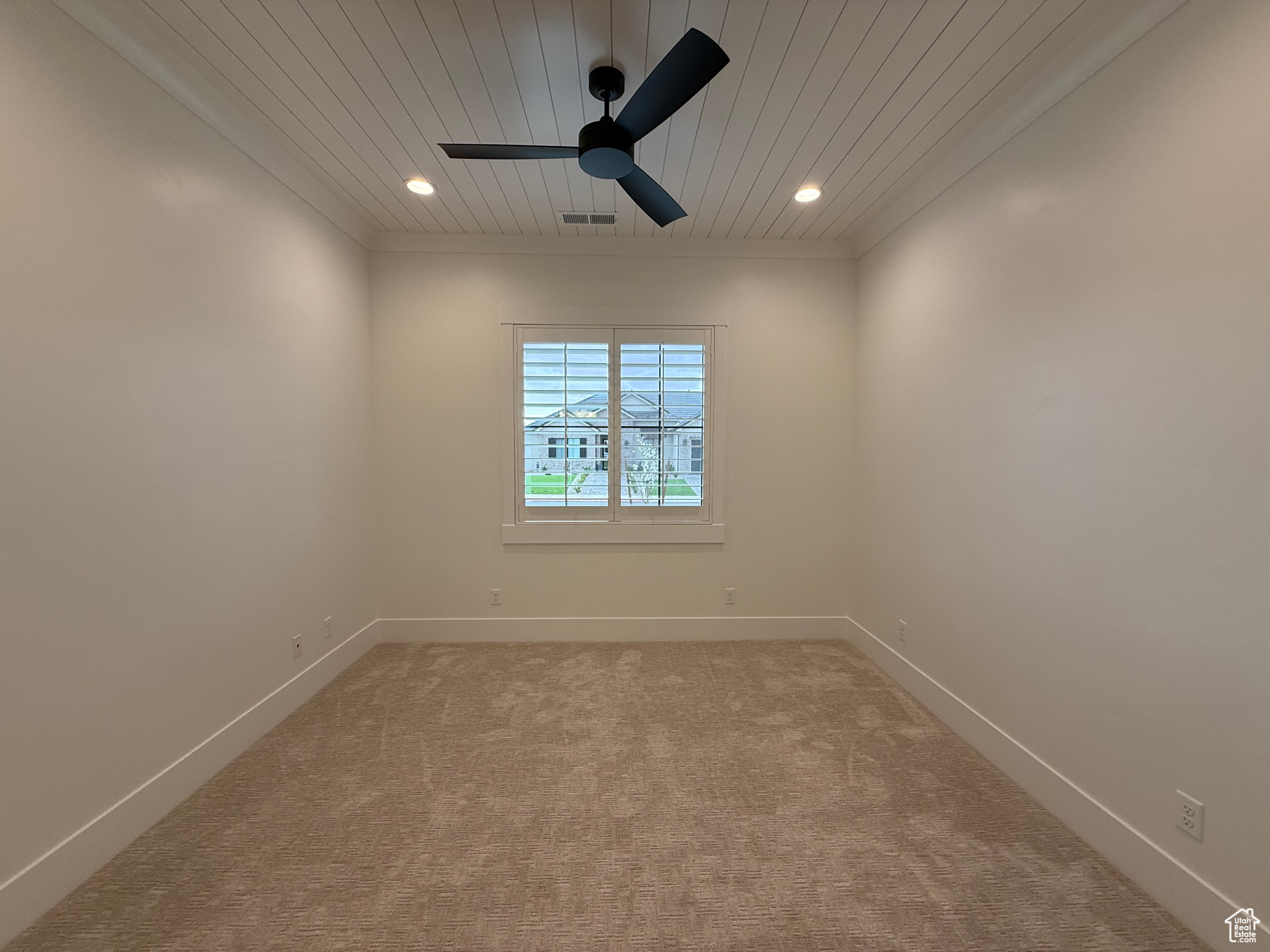 Empty room featuring light colored carpet, recessed lighting, baseboards, and visible vents