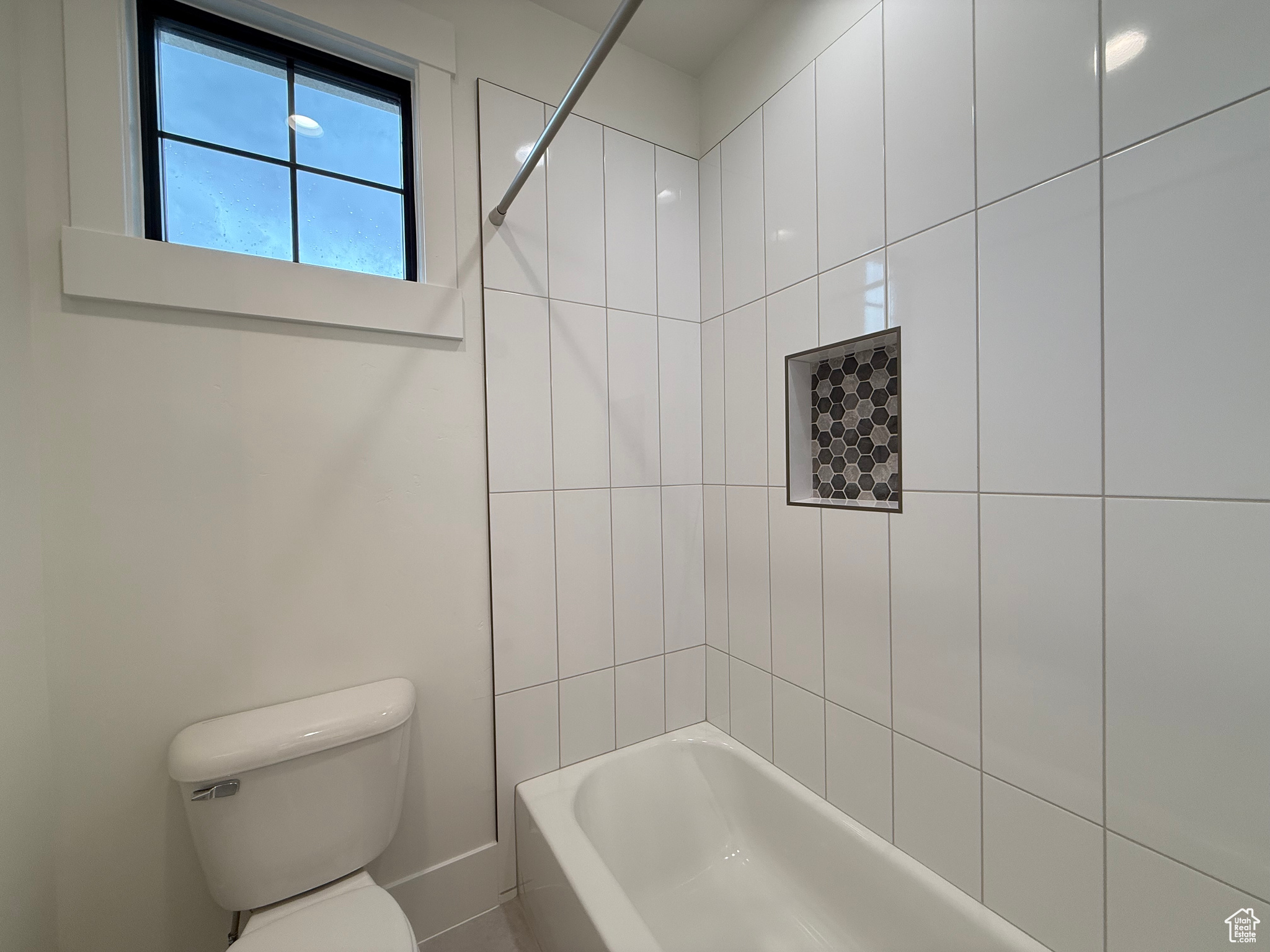 Bathroom with bathtub / shower combination and toilet