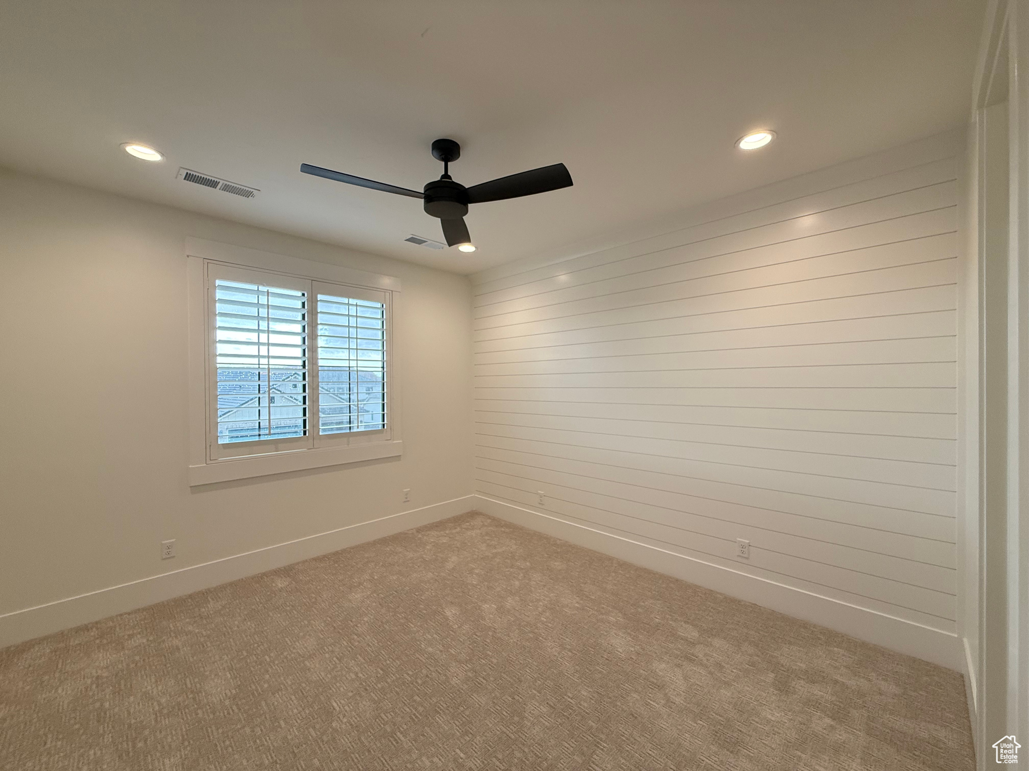 Empty room with visible vents, recessed lighting, baseboards, and carpet floors