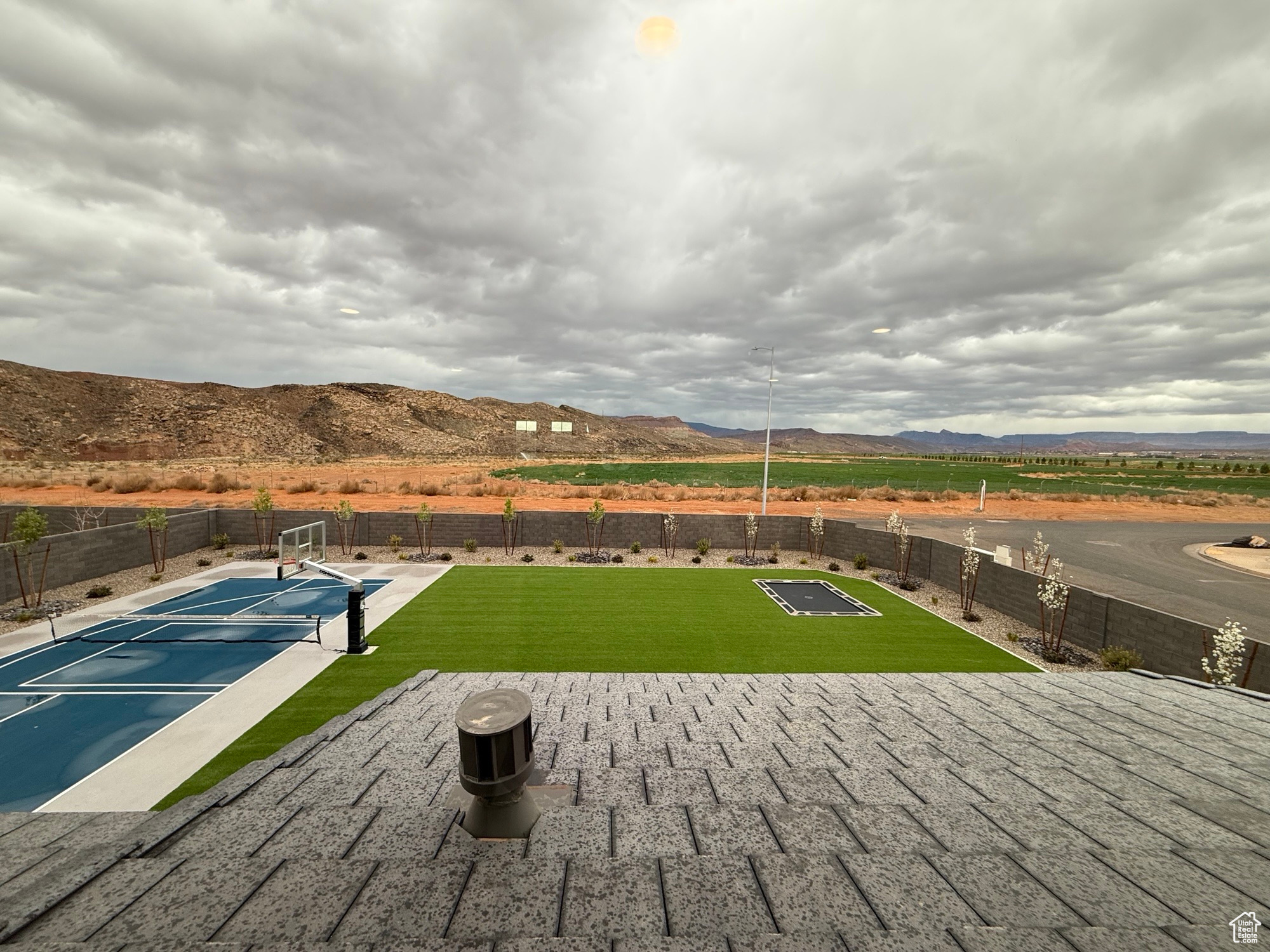 View of patio with fence and a mountain view