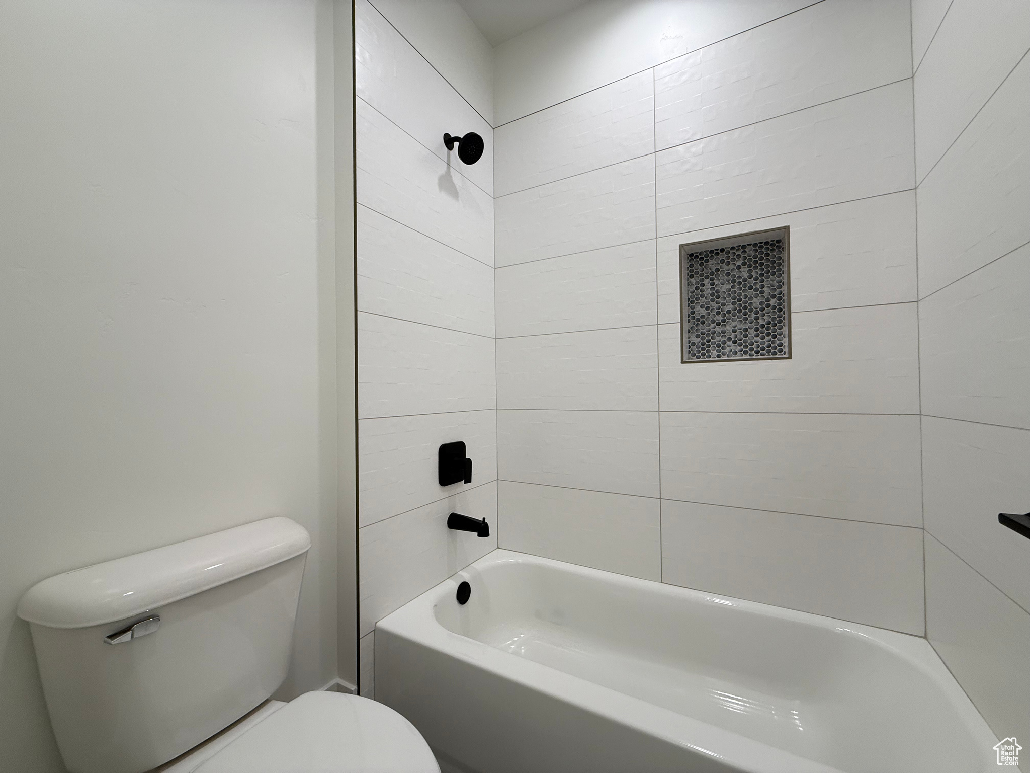 Full bath featuring toilet and shower / bathtub combination