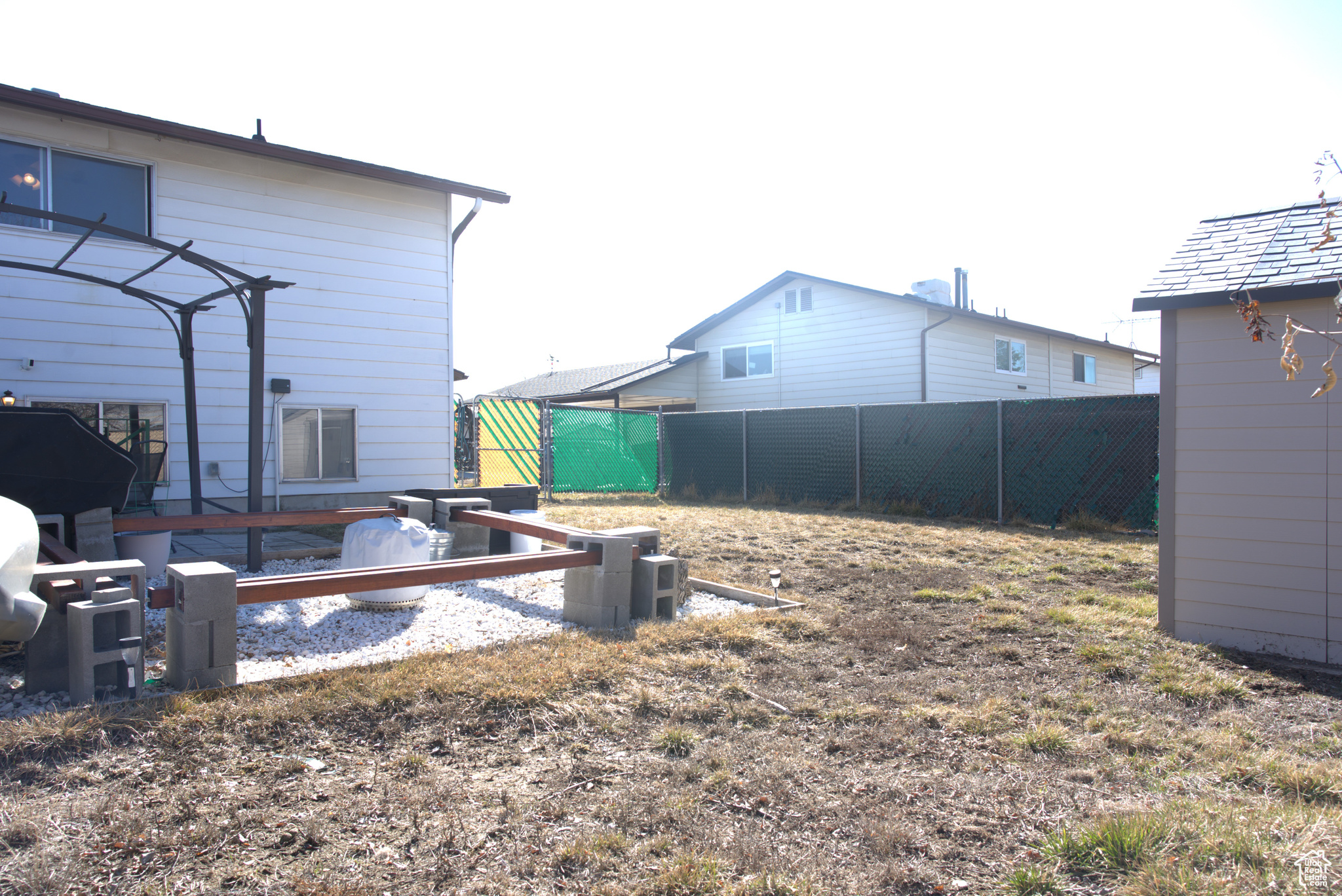 View of yard with an outbuilding and fence