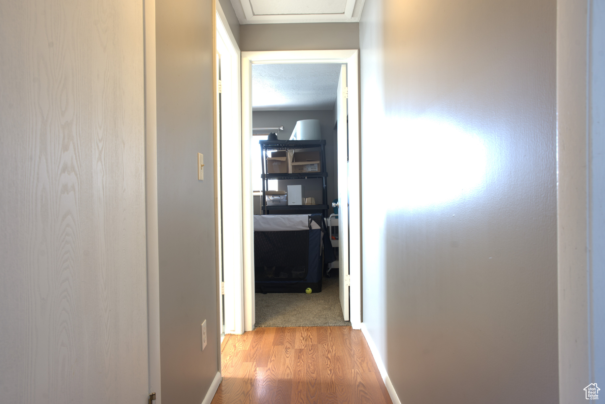 Hall with light wood-type flooring and baseboards